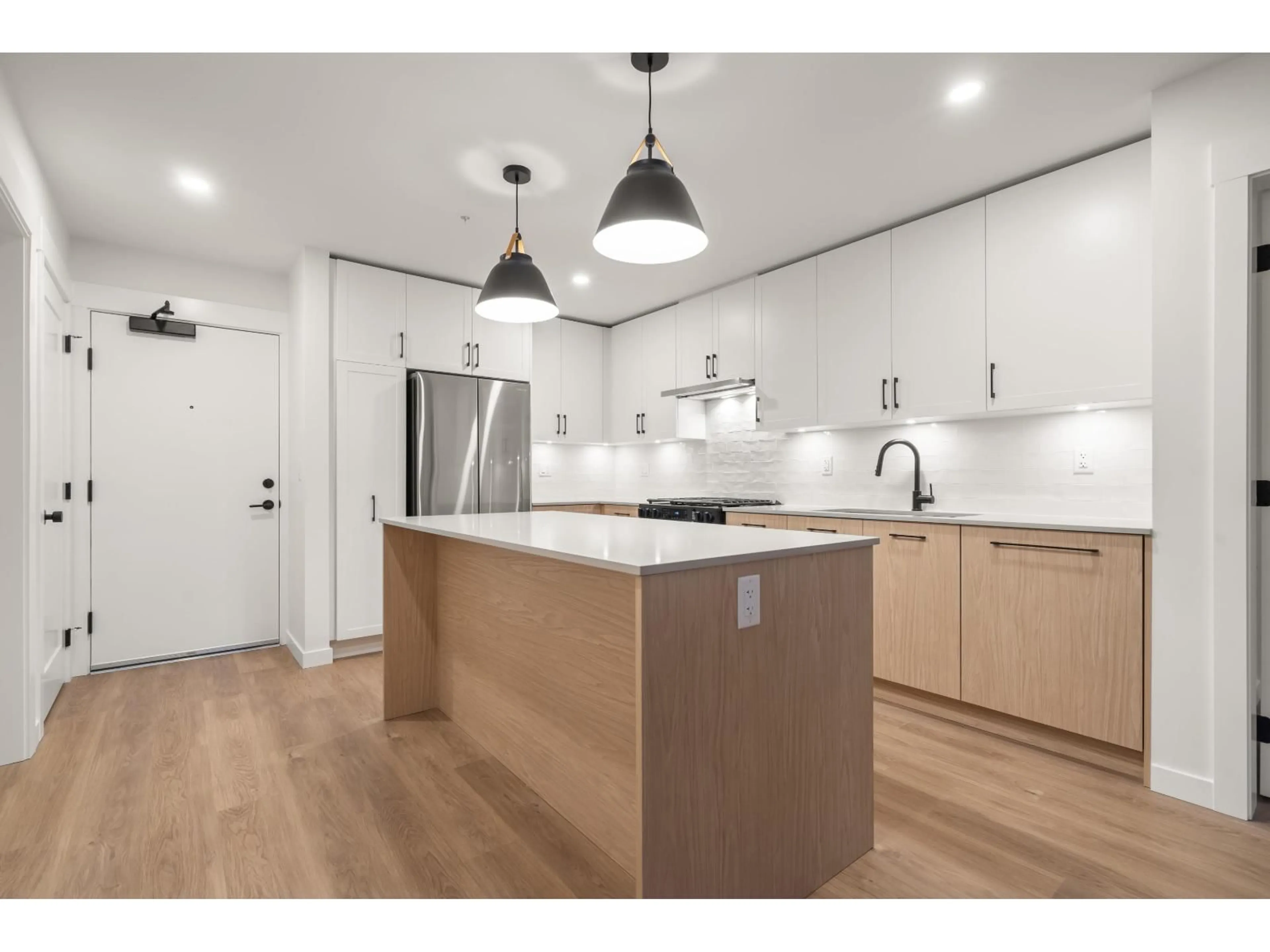 Open concept kitchen, wood/laminate floor for 203 - 27218 ALDERGROVE TOWN CENTRE DRIVE, Langley British Columbia V4W3N7