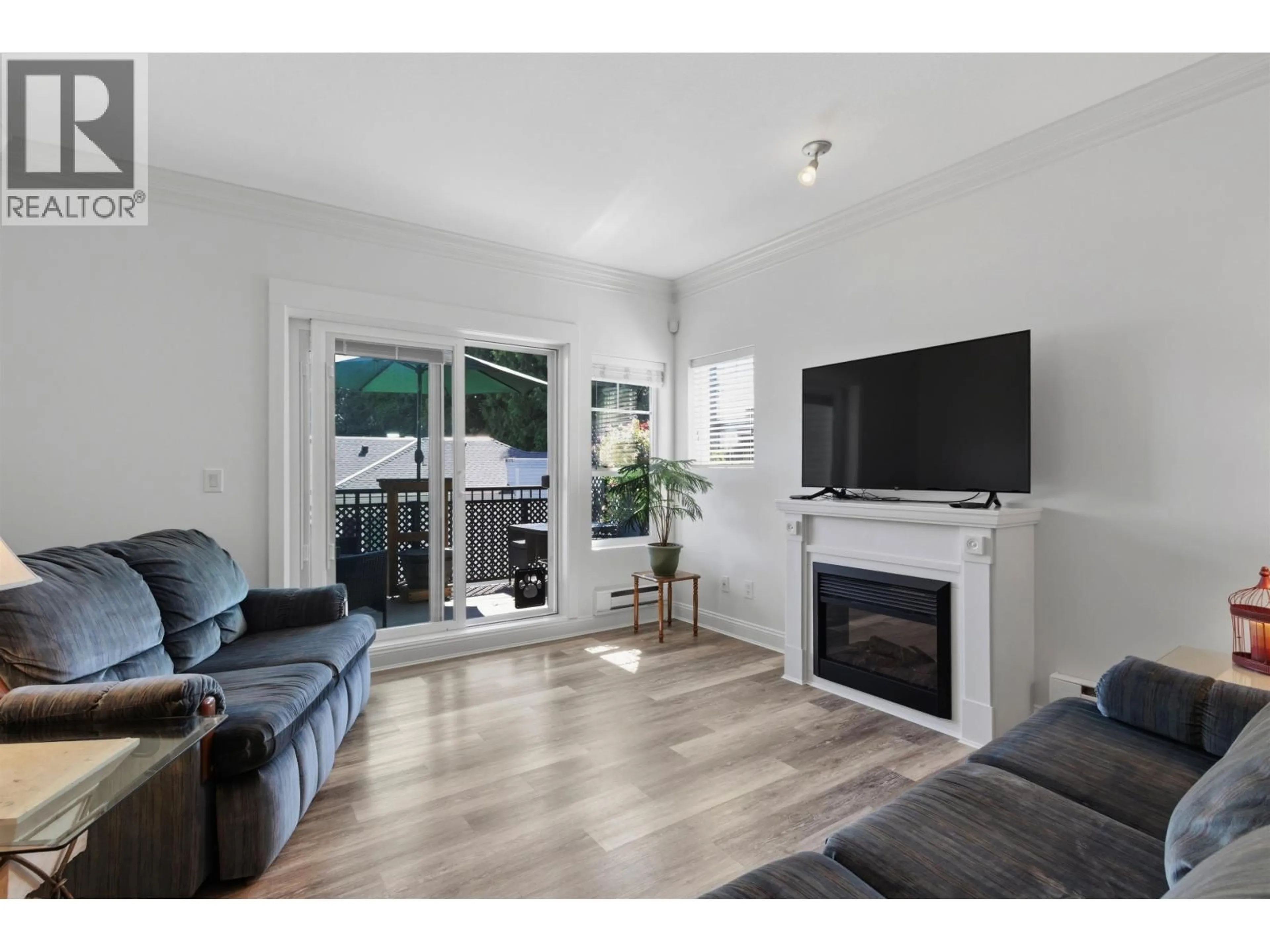 Living room with furniture, wood/laminate floor for 411 - 22150 DEWDNEY TRUNK ROAD, Maple Ridge British Columbia V2X3H6