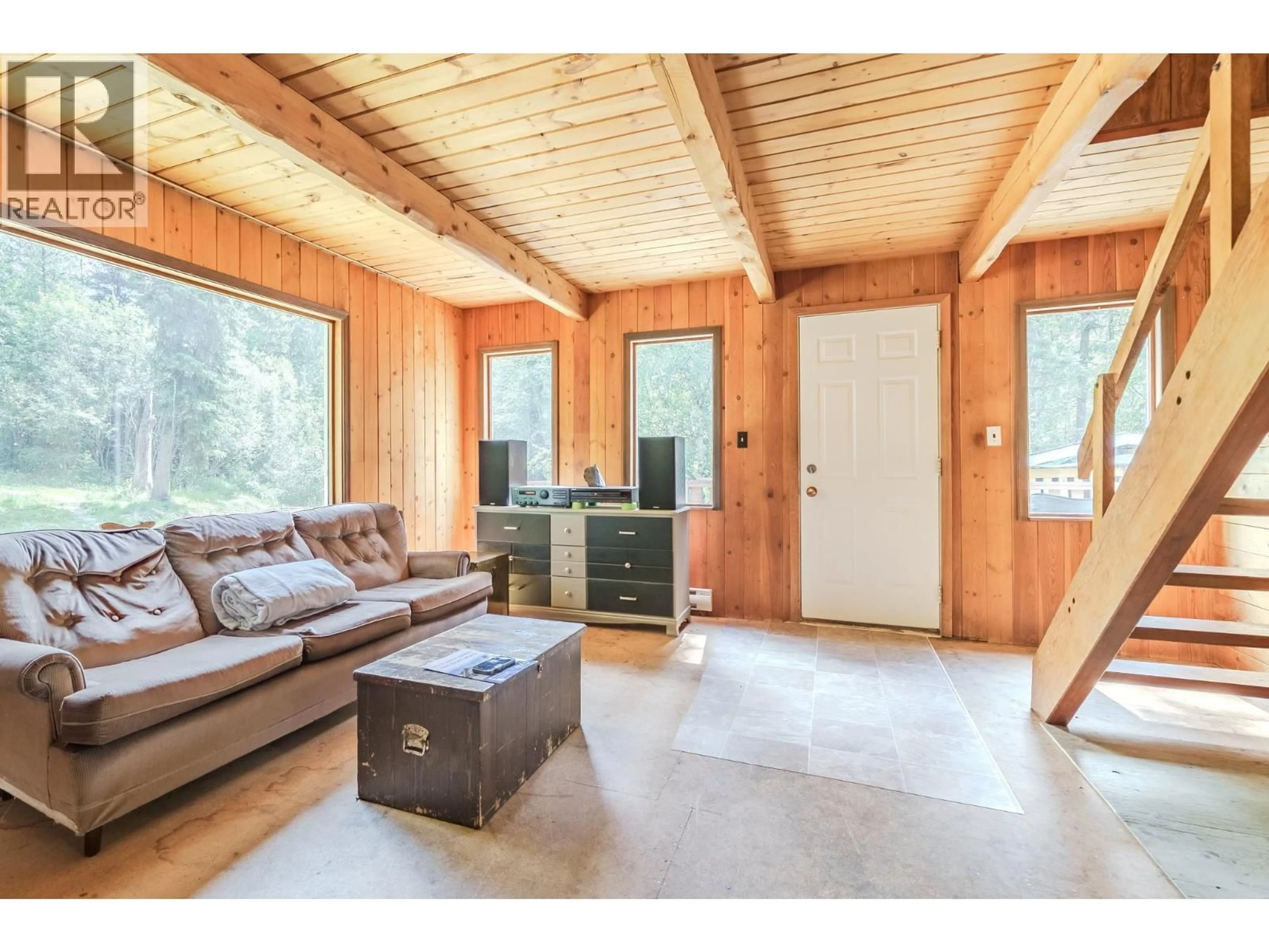 Living room with furniture, wood/laminate floor for 3669 BRADLEY CREEK ROAD, Forest Grove British Columbia V0K1M0