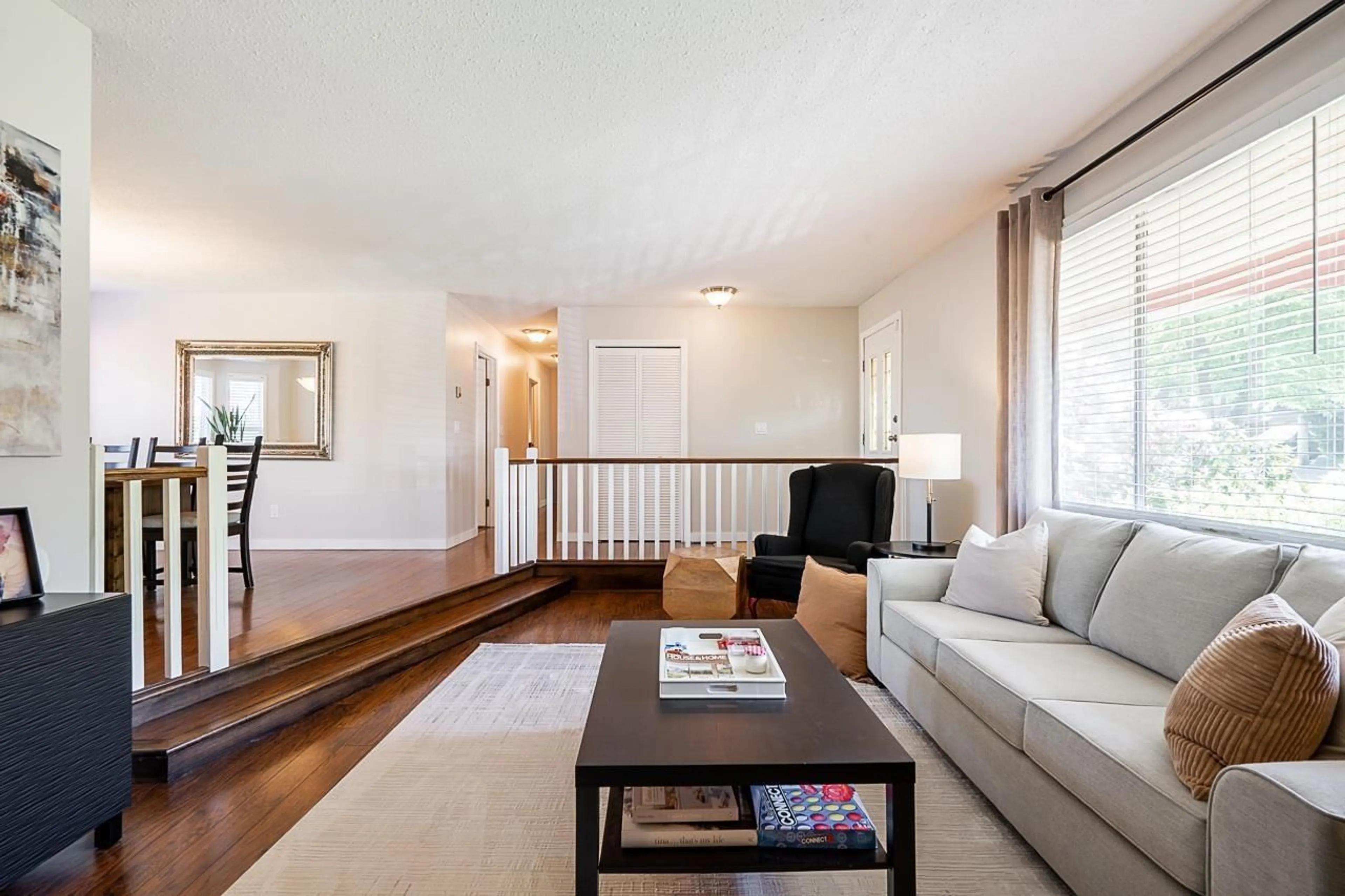 Living room with furniture, wood/laminate floor for 4628 207A STREET, Langley British Columbia V3A5N3