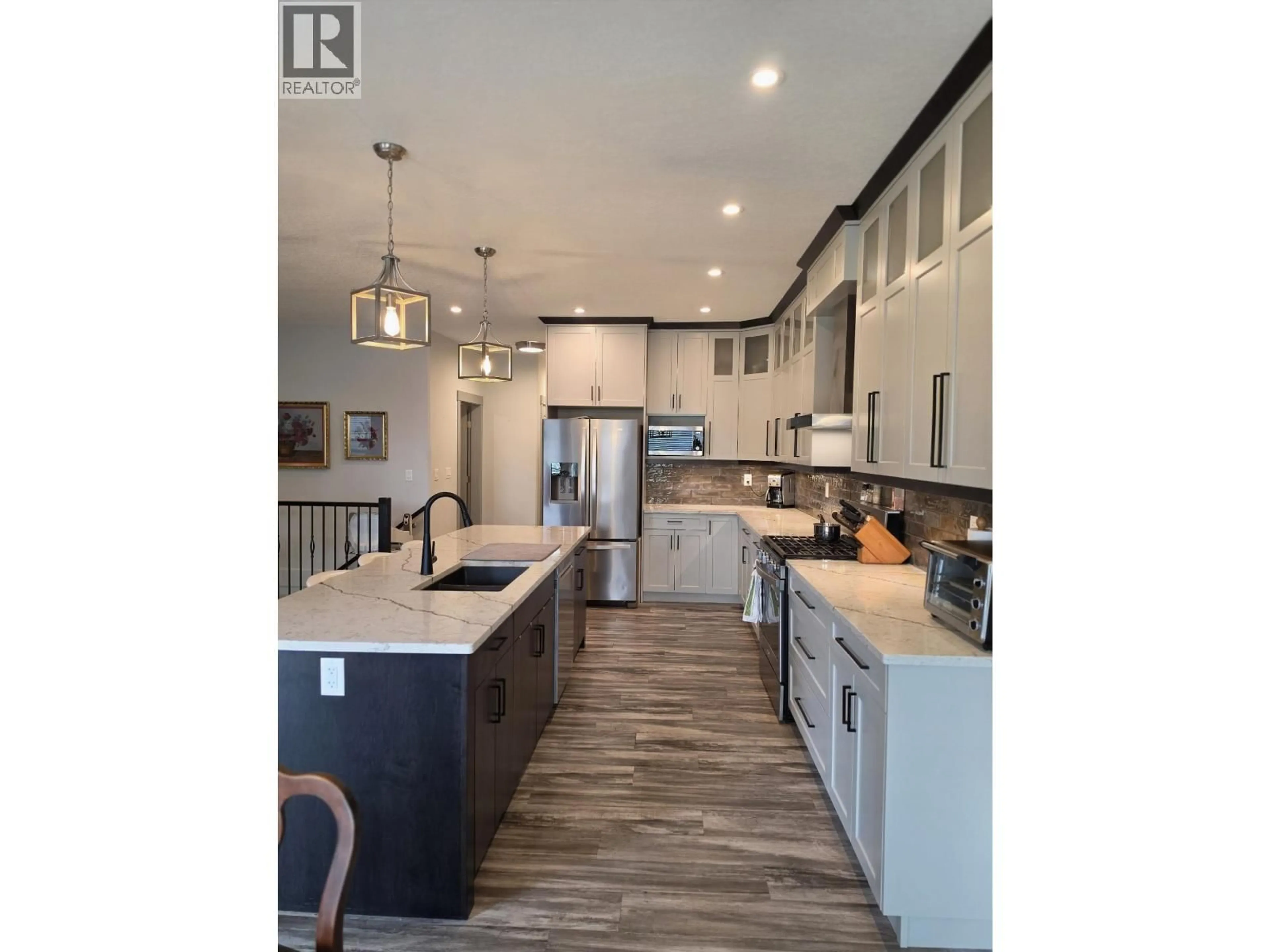 Open concept kitchen, wood/laminate floor for 7118 FOXRIDGE COURT, Prince George British Columbia V2N0H2