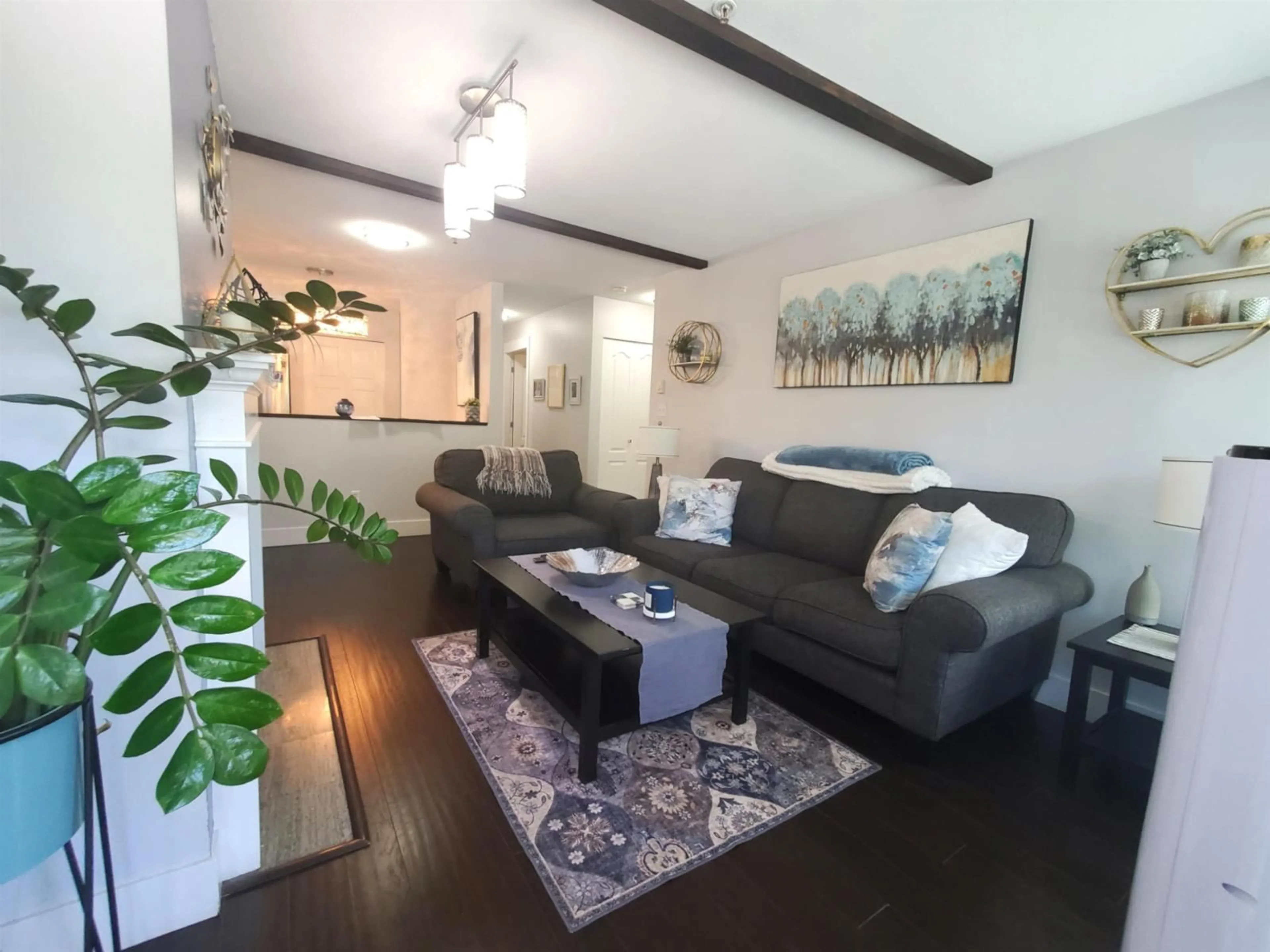 Living room with furniture, wood/laminate floor for 208 - 2964 TRETHEWEY STREET, Abbotsford British Columbia V2T6P4