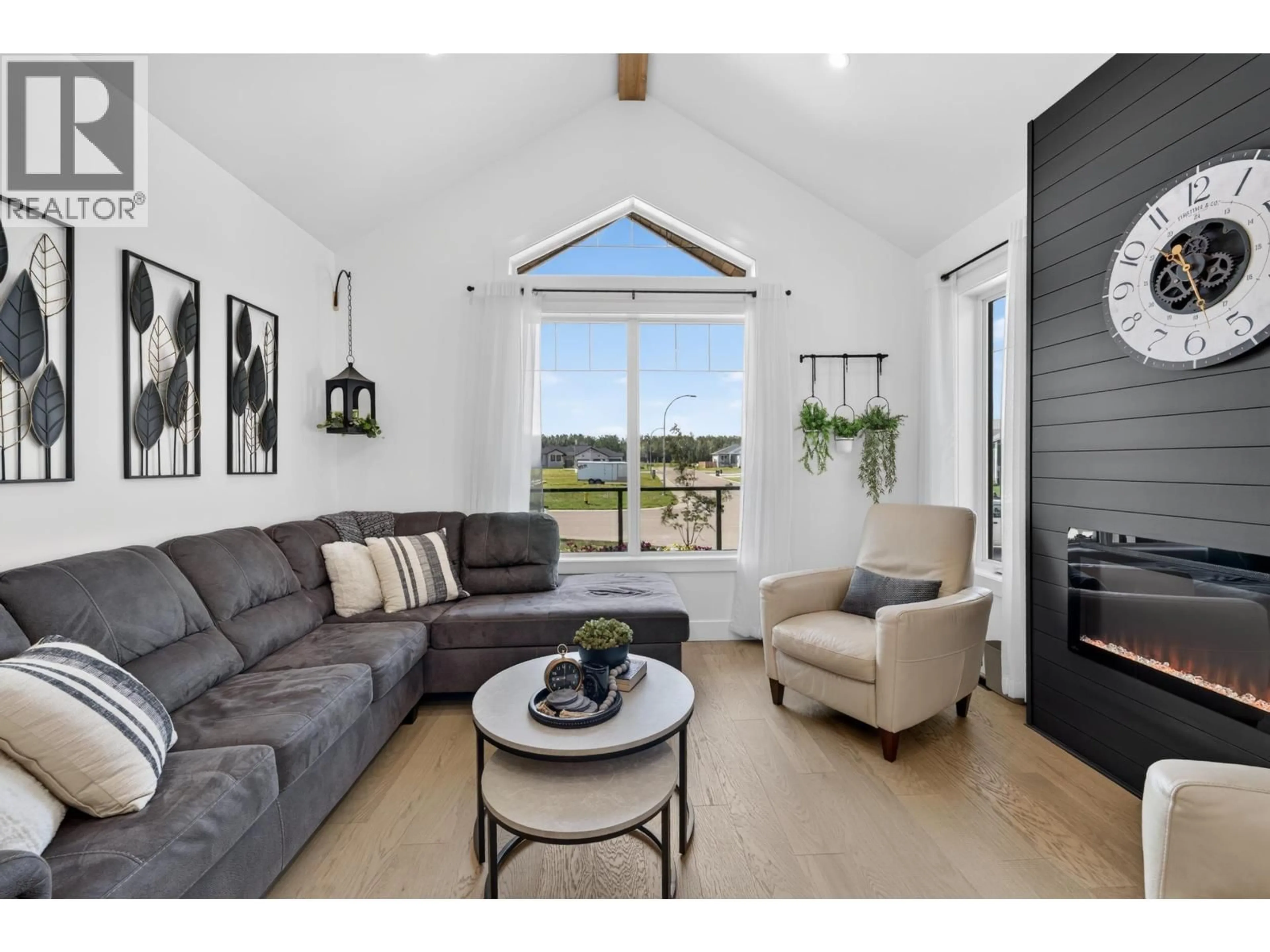 Living room with furniture, wood/laminate floor for 11212 114 AVENUE, Fort St. John British Columbia V1J0R5