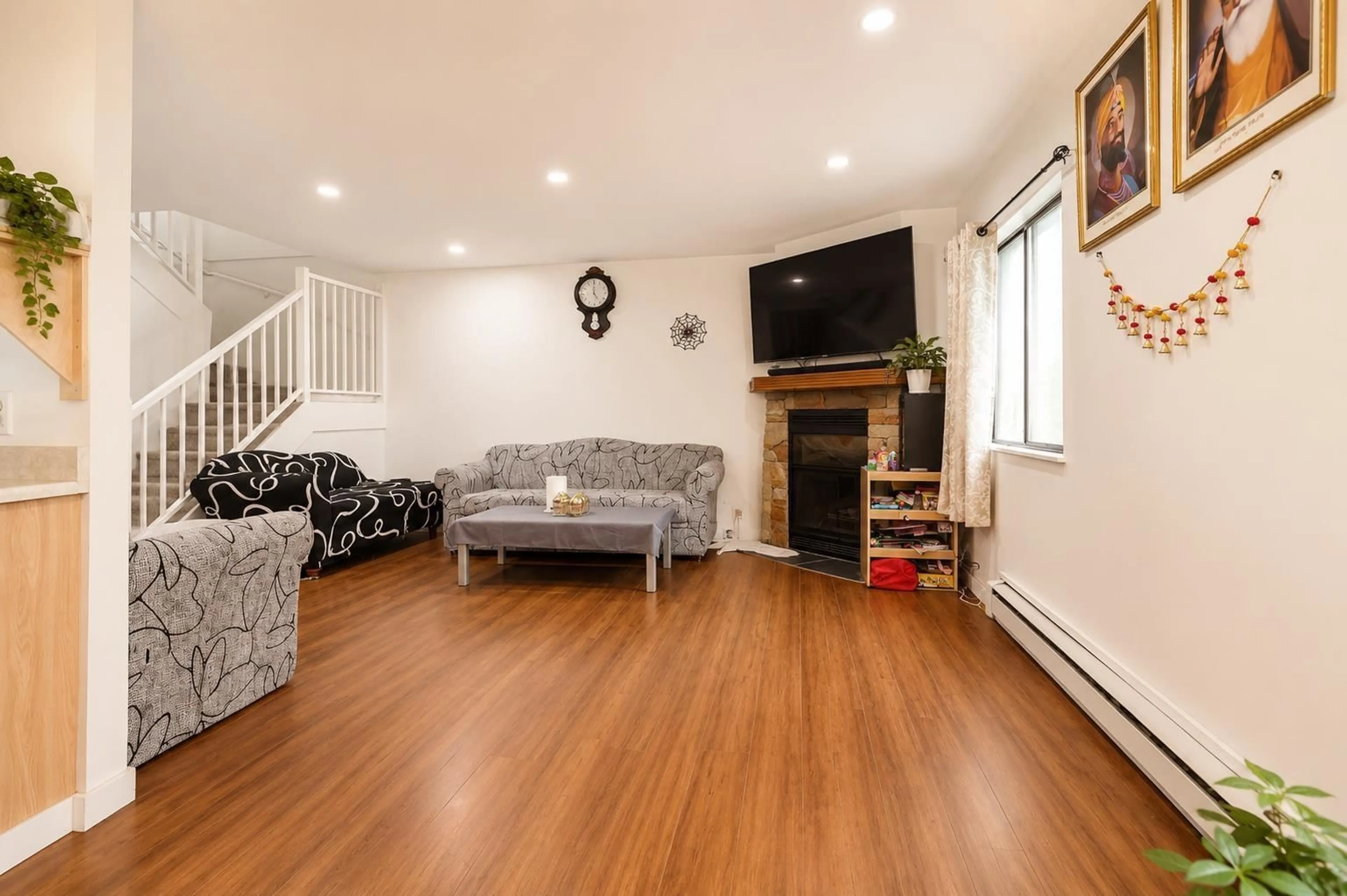 Living room with furniture, wood/laminate floor for 208 - 7144 133B STREET, Surrey British Columbia V3W8A4