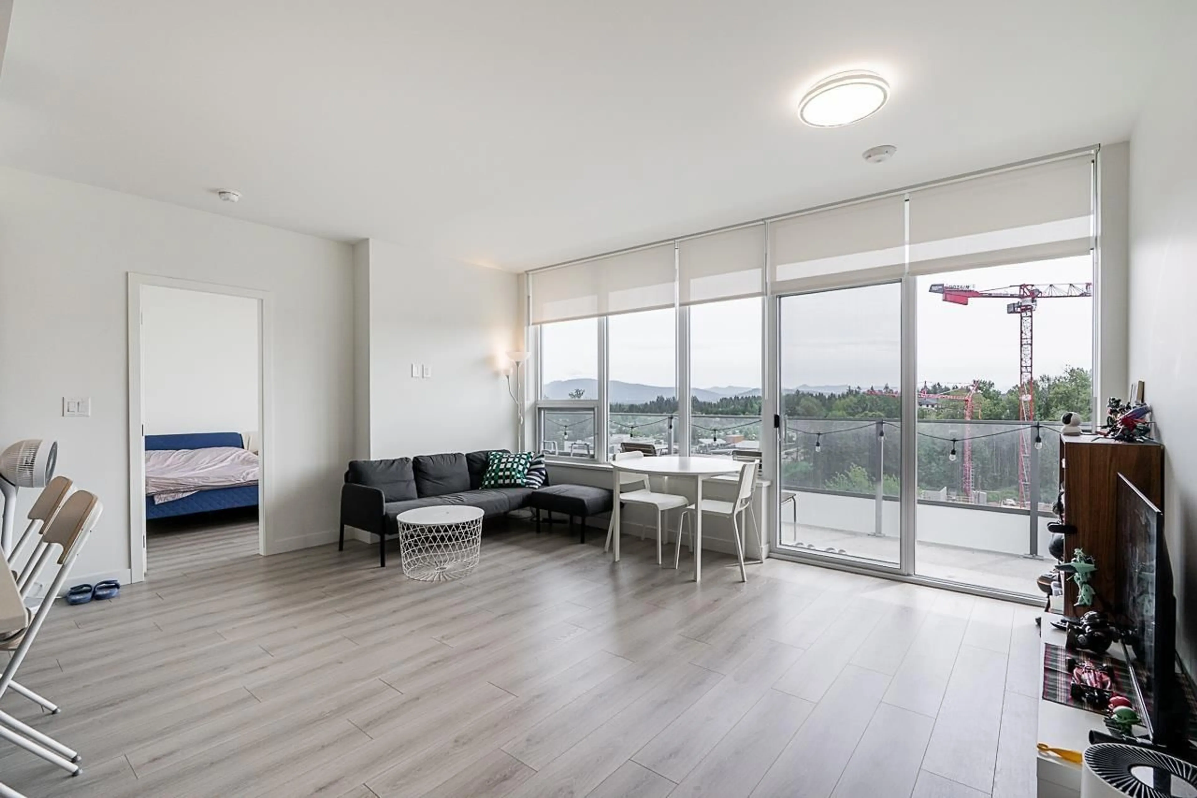 Living room with furniture, wood/laminate floor for 901 - 8551 201 STREET, Langley British Columbia V2Y3Y5