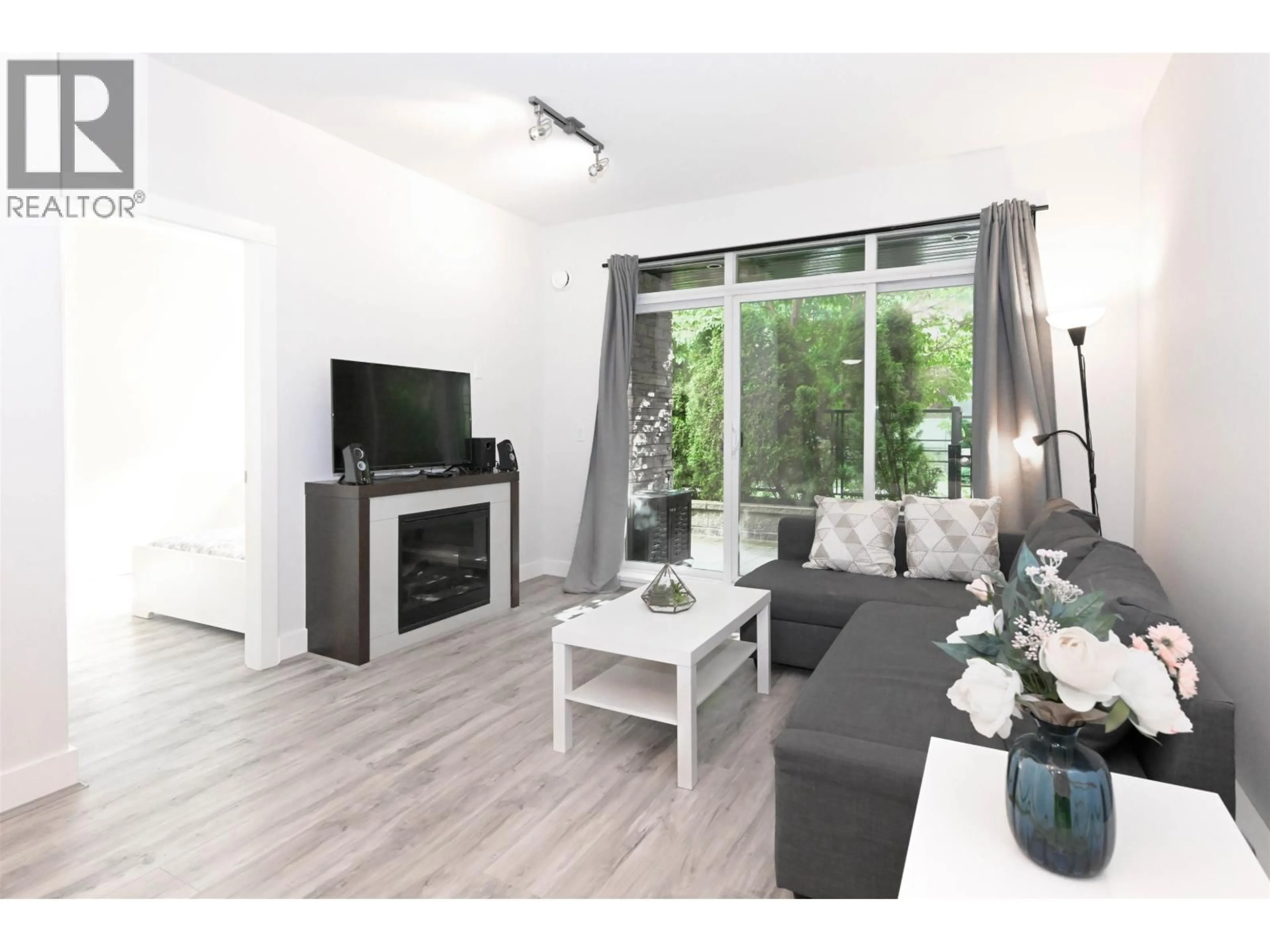 Living room with furniture, wood/laminate floor for 107 - 5928 BIRNEY AVENUE, Vancouver British Columbia V6S0B5
