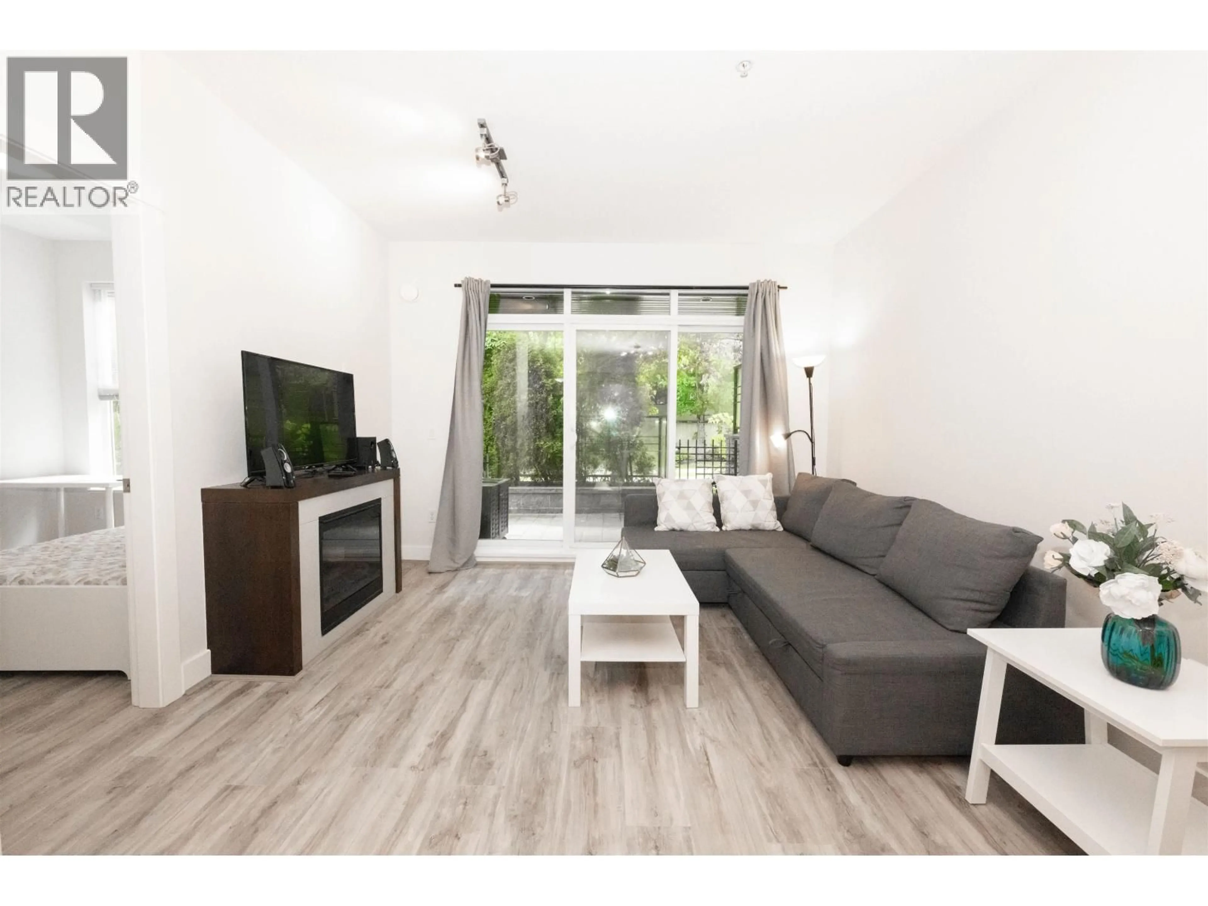 Living room with furniture, wood/laminate floor for 107 - 5928 BIRNEY AVENUE, Vancouver British Columbia V6S0B5