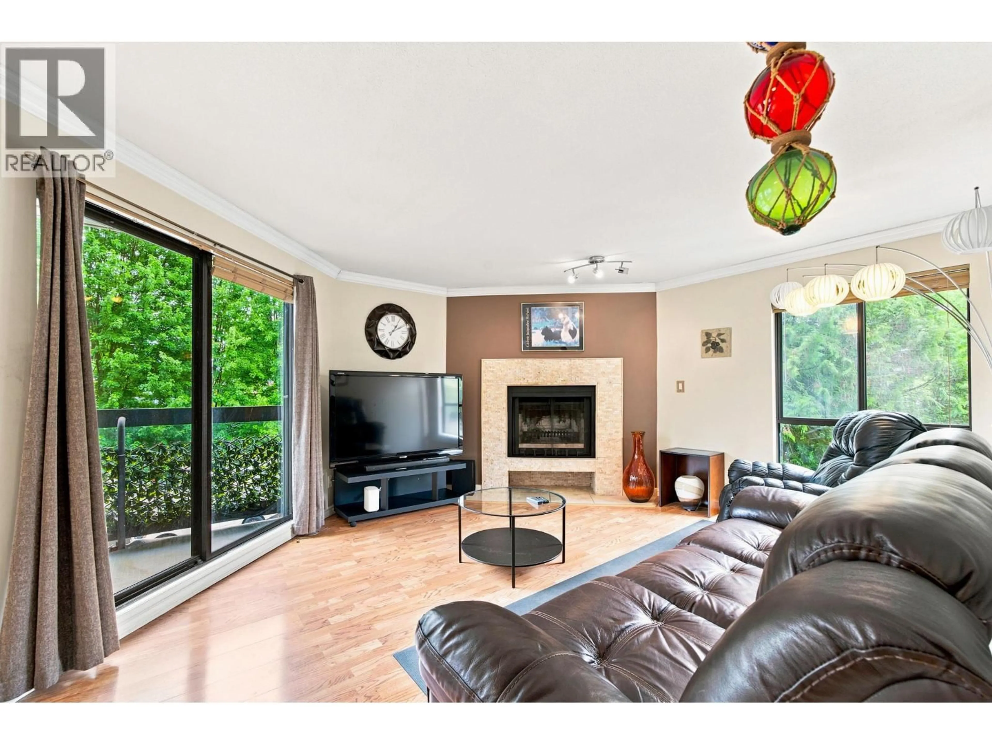 Living room with furniture, wood/laminate floor for 104 - 2181 PANORAMA DRIVE, North Vancouver British Columbia V7G1V3