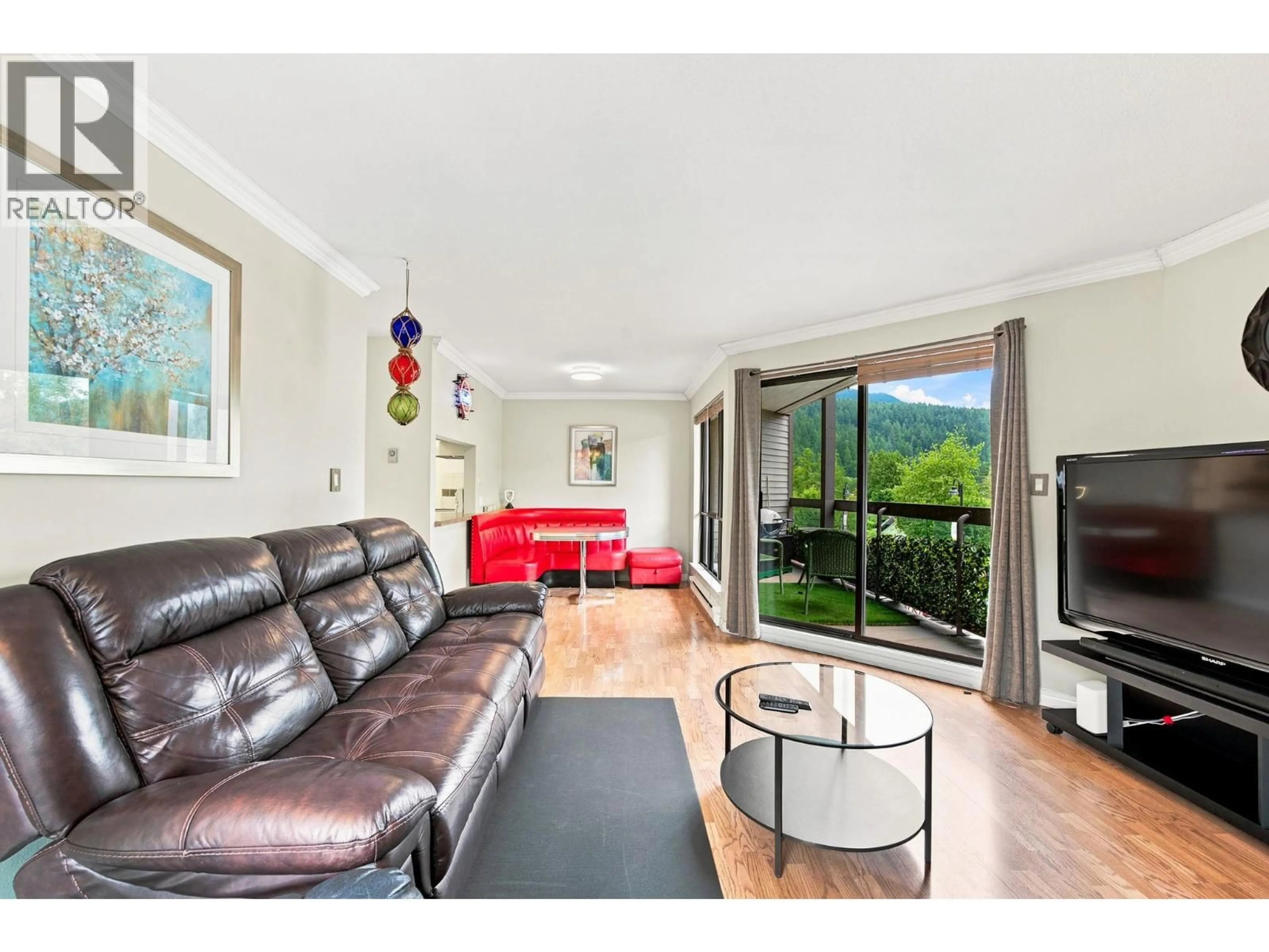 Living room with furniture, wood/laminate floor for 104 - 2181 PANORAMA DRIVE, North Vancouver British Columbia V7G1V3
