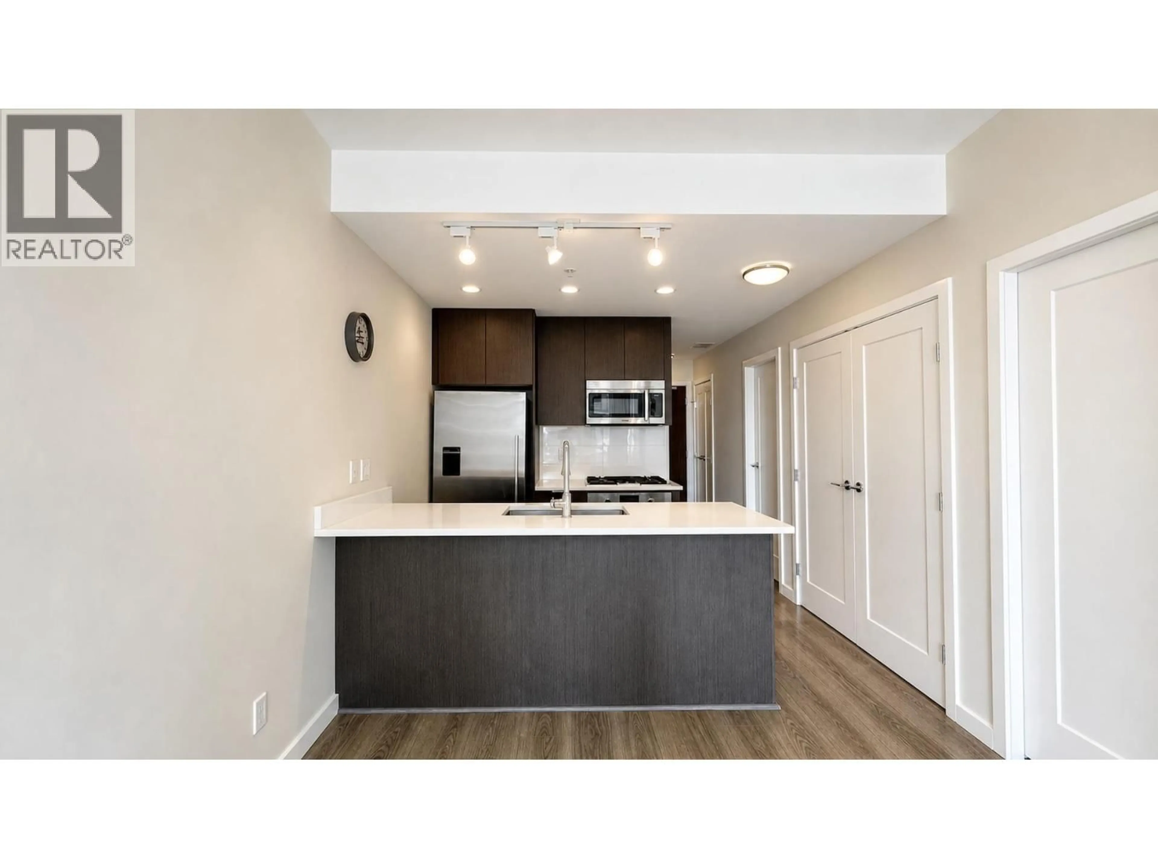 Open concept kitchen, wood/laminate floor for 706 - 3333 SEXSMITH ROAD, Richmond British Columbia V6X0R7