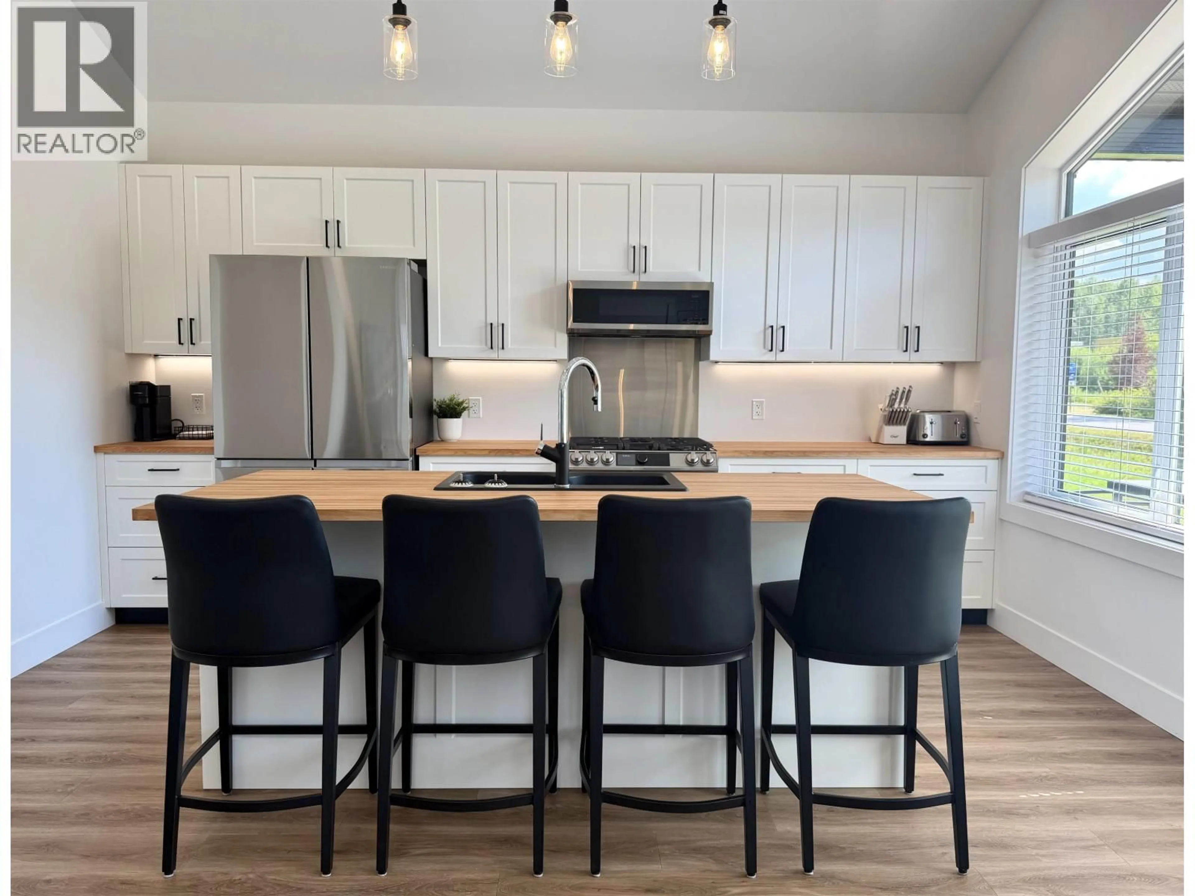 Open concept kitchen, wood/laminate floor for 3418 RAILWAY AVENUE, Smithers British Columbia V0J2N0