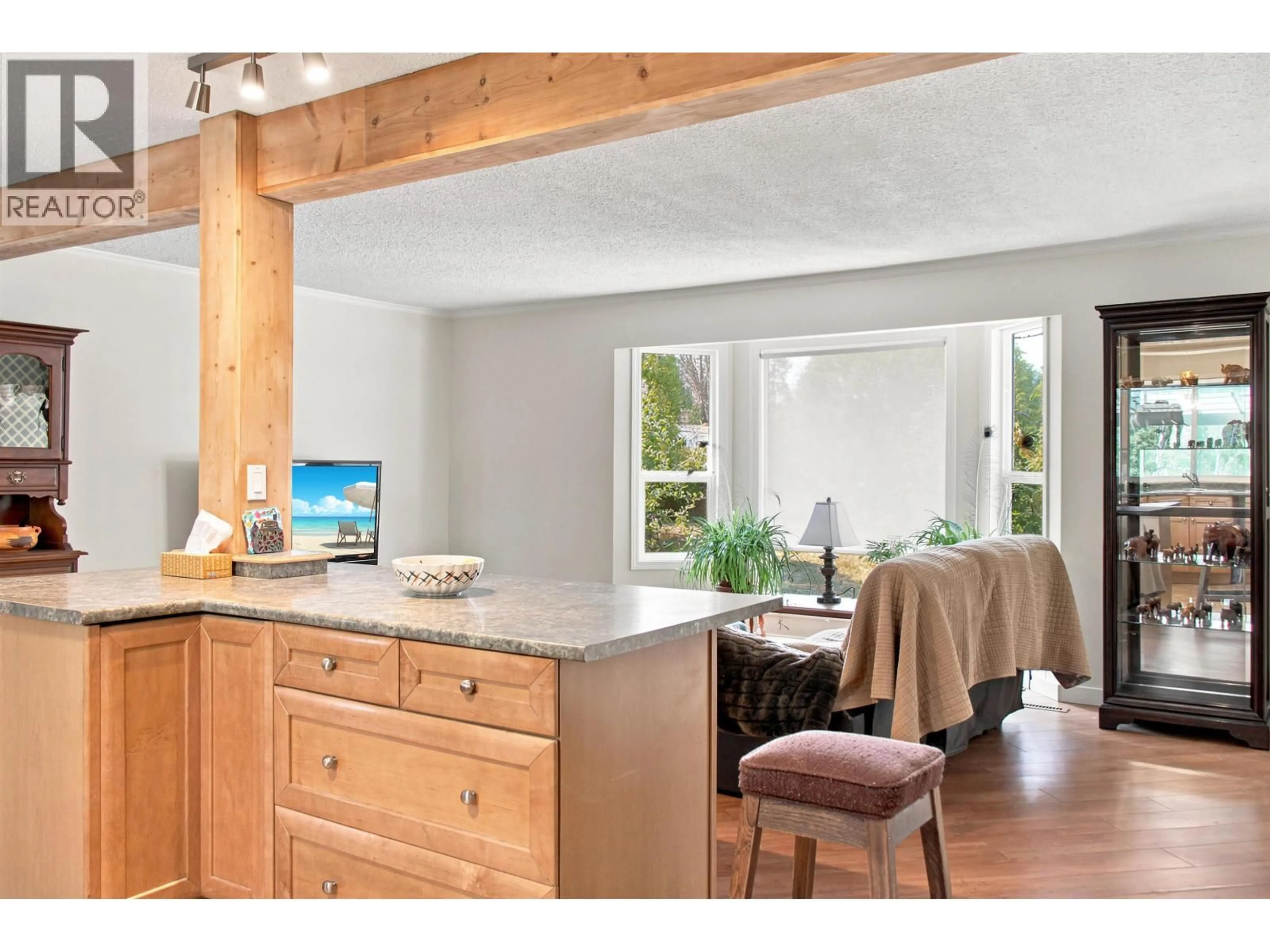 Open concept kitchen, wood/laminate floor for 5513 PARK DRIVE, 103 Mile House British Columbia V0K2E1