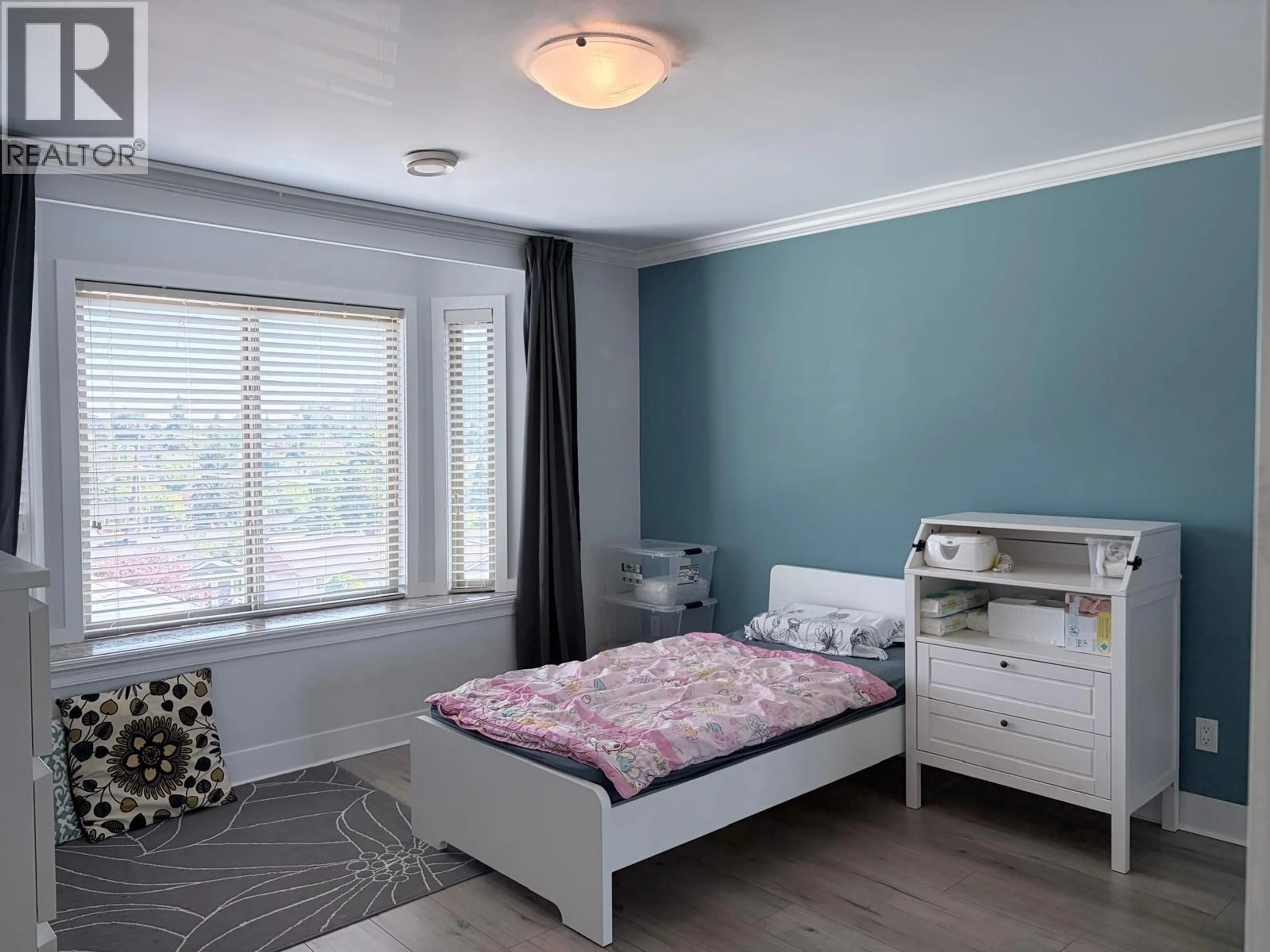 Bedroom with bed, wood/laminate floor for 8068 11TH AVENUE, Burnaby British Columbia V3N2N7