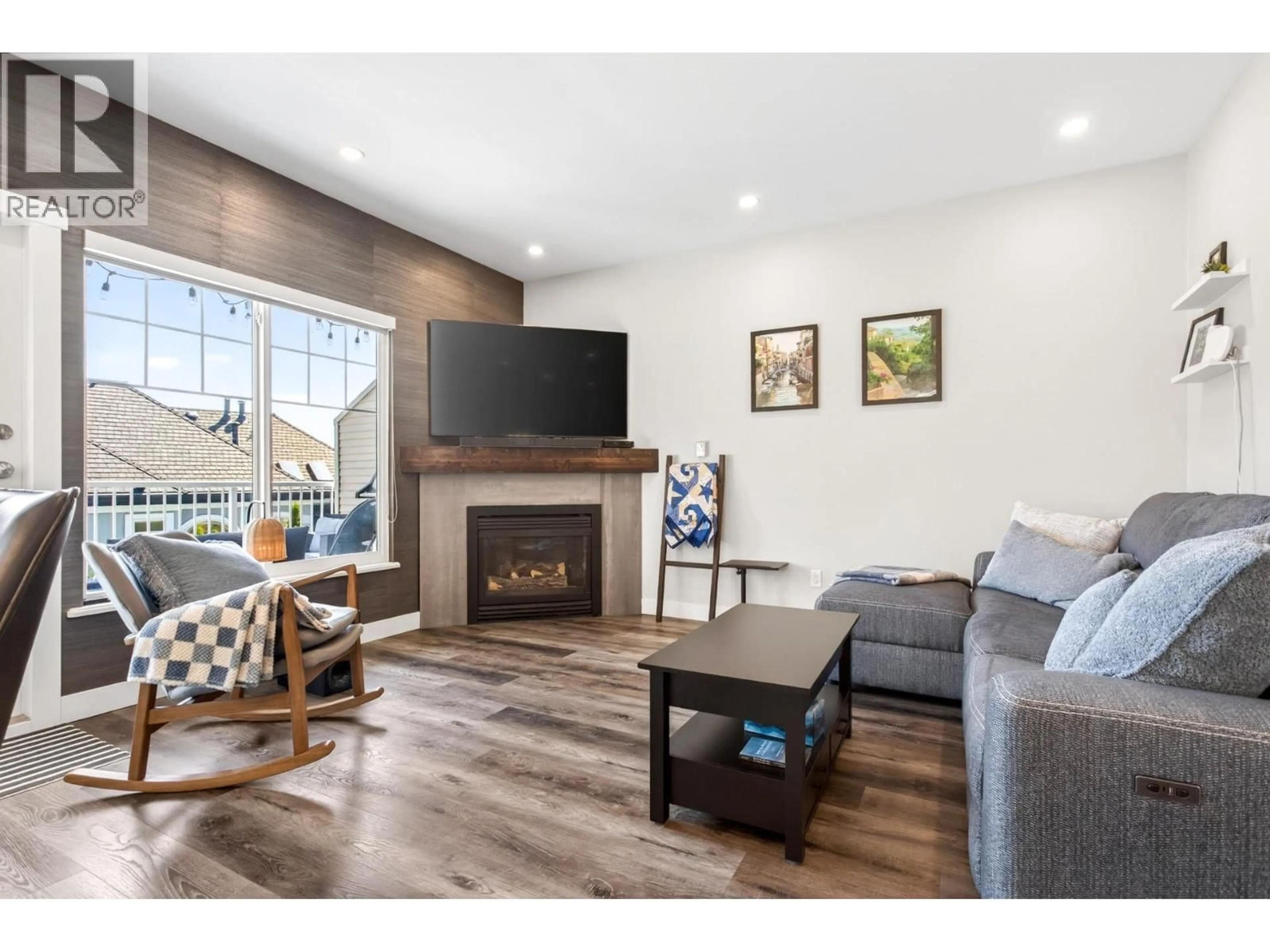 Living room with furniture, wood/laminate floor for 21 - 1751 PADDOCK DRIVE, Coquitlam British Columbia V3E3M2