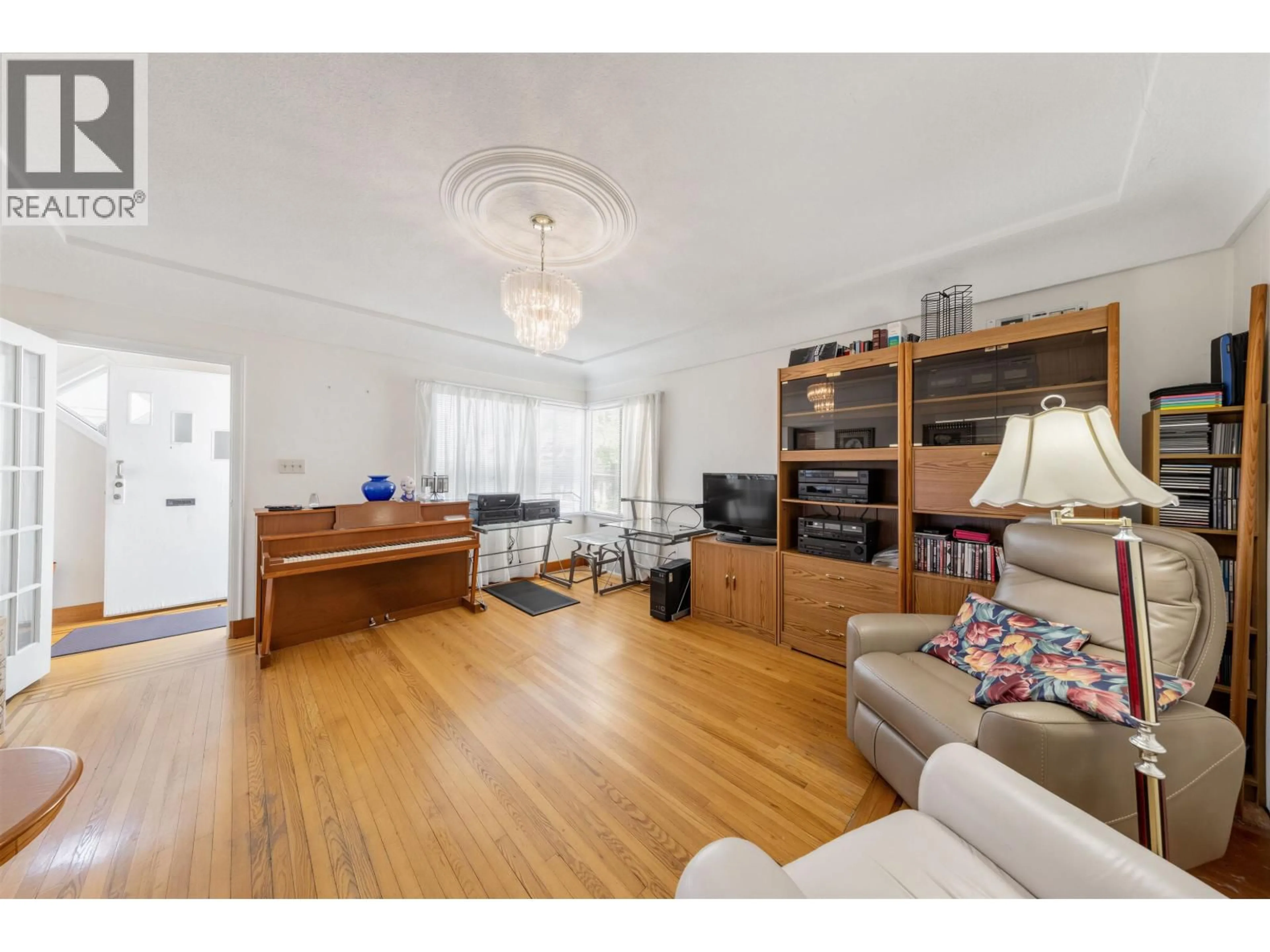Living room with furniture, wood/laminate floor for 3378 26TH AVENUE, Vancouver British Columbia V5R1L9