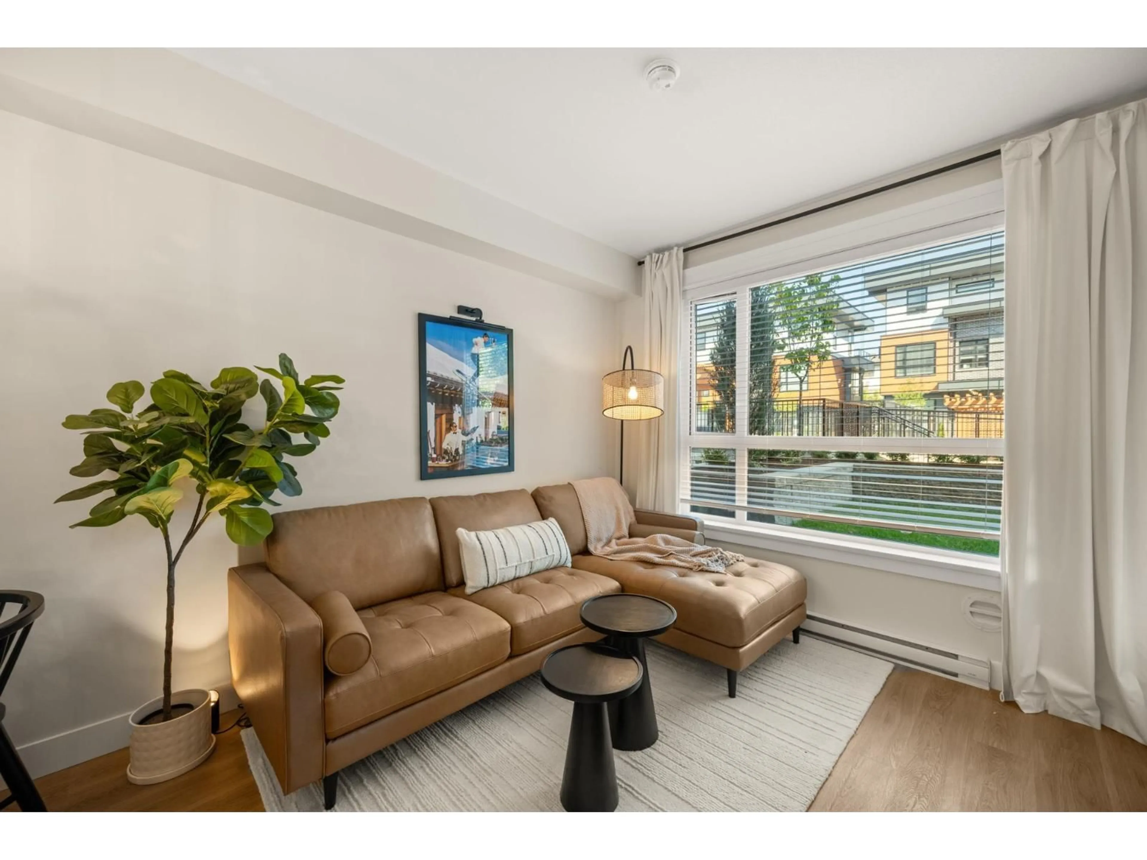 Living room with furniture, wood/laminate floor for 407 - 20926 83 AVENUE, Langley British Columbia V2Y3Y9