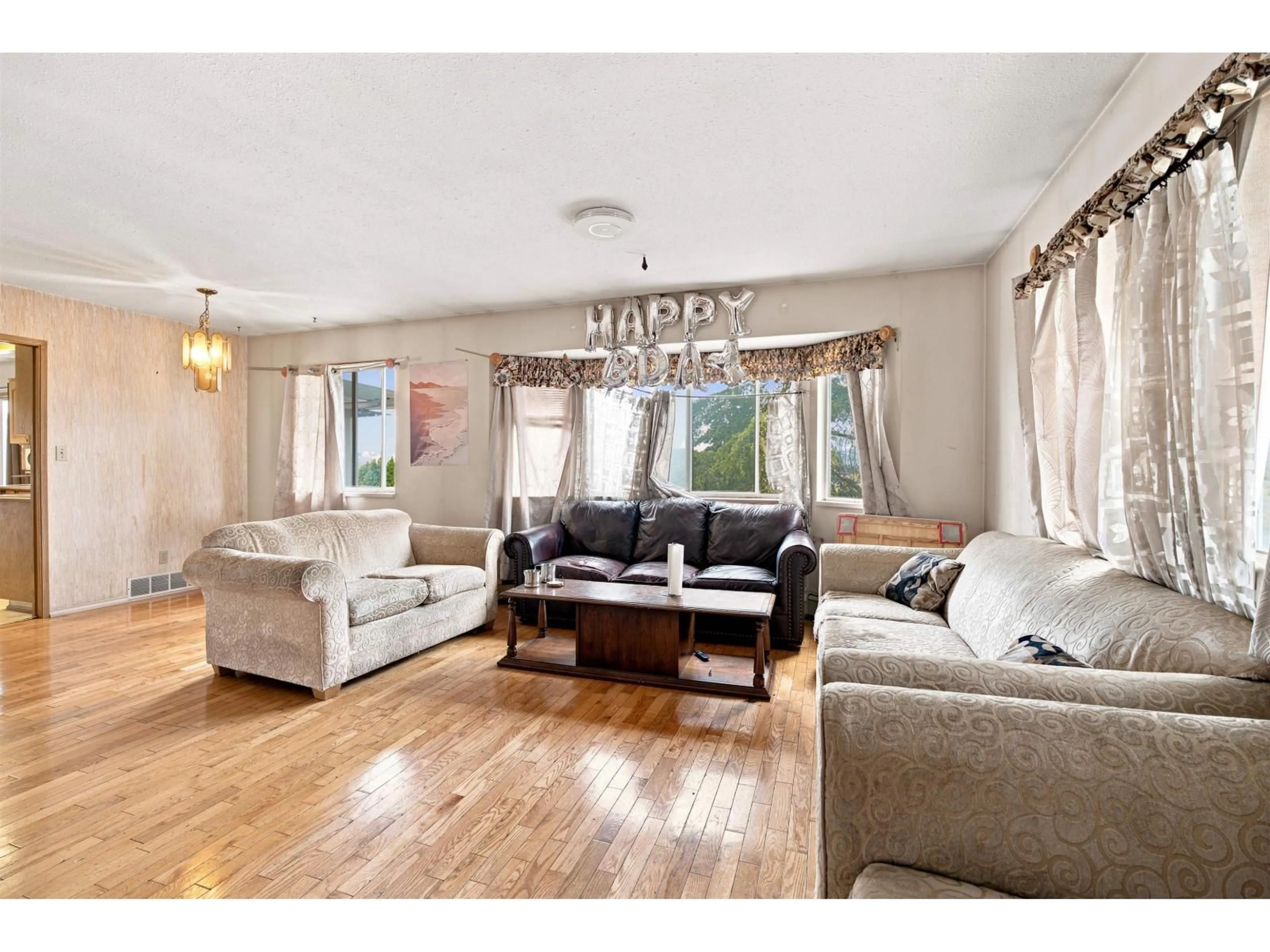 Living room with furniture, wood/laminate floor for 12191 101A AVENUE, Surrey British Columbia V3V2Z9
