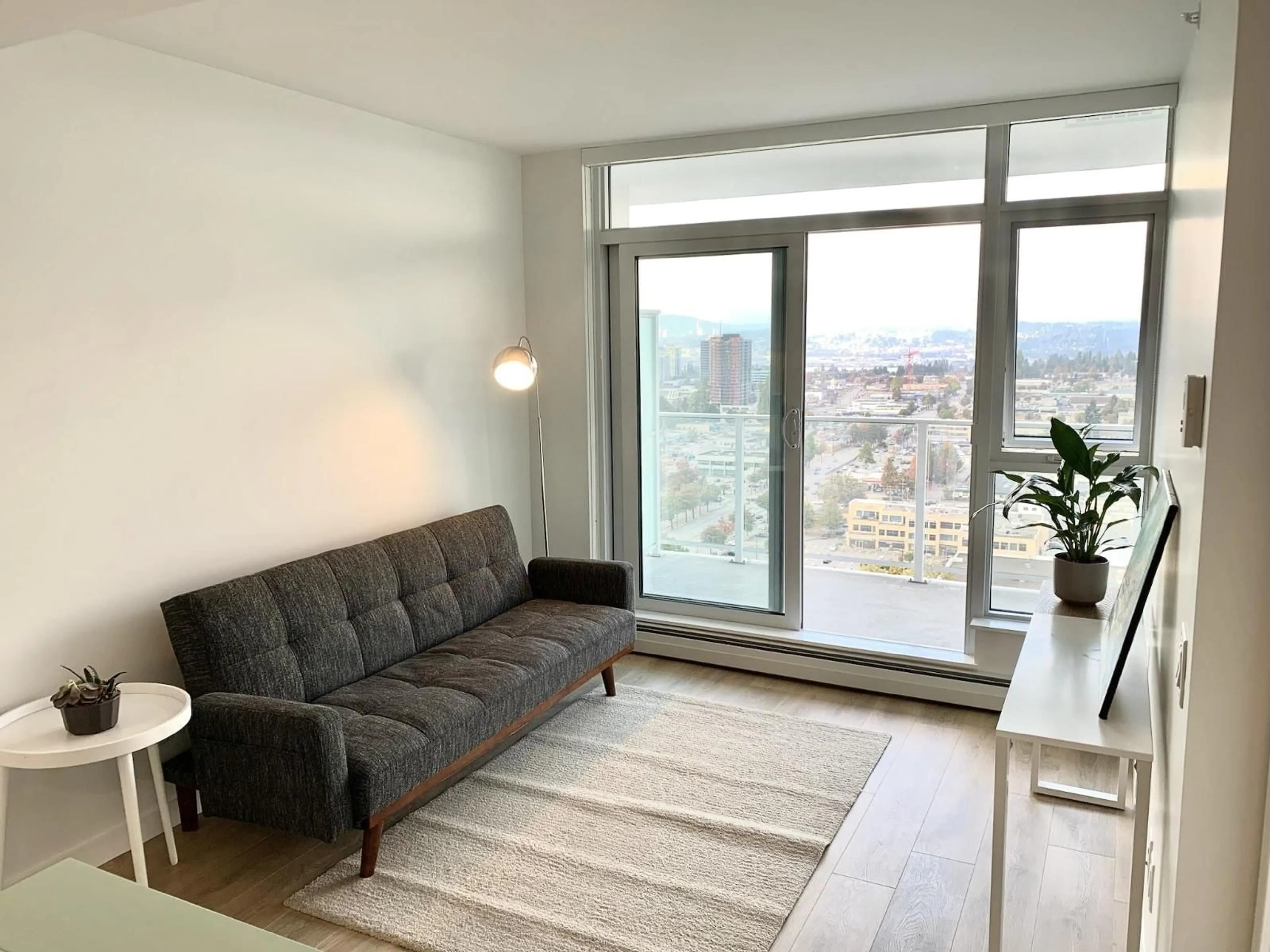 Living room with furniture, wood/laminate floor for 2501 - 13685 102 AVENUE, Surrey British Columbia V3T1N7