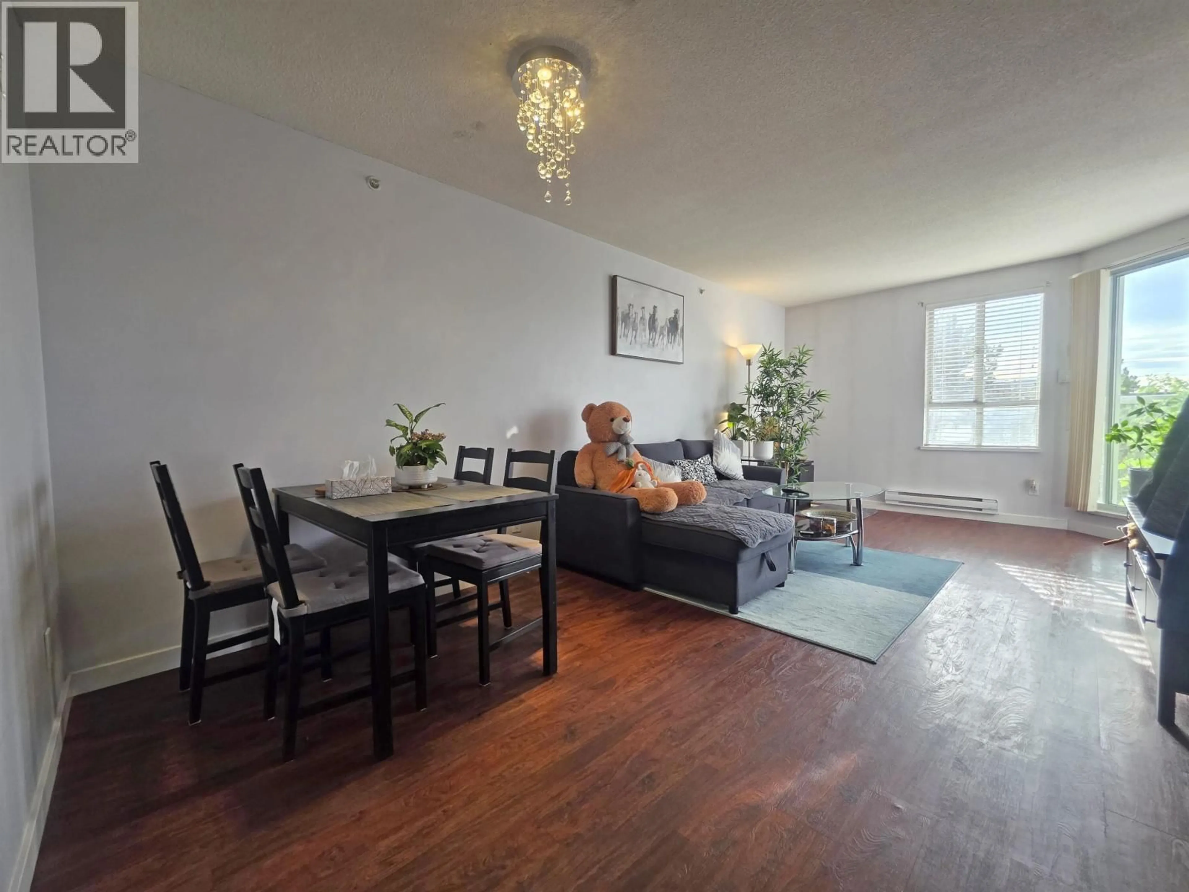 Living room with furniture, wood/laminate floor for 607 - 3455 ASCOT PLACE, Vancouver British Columbia V5R6B7