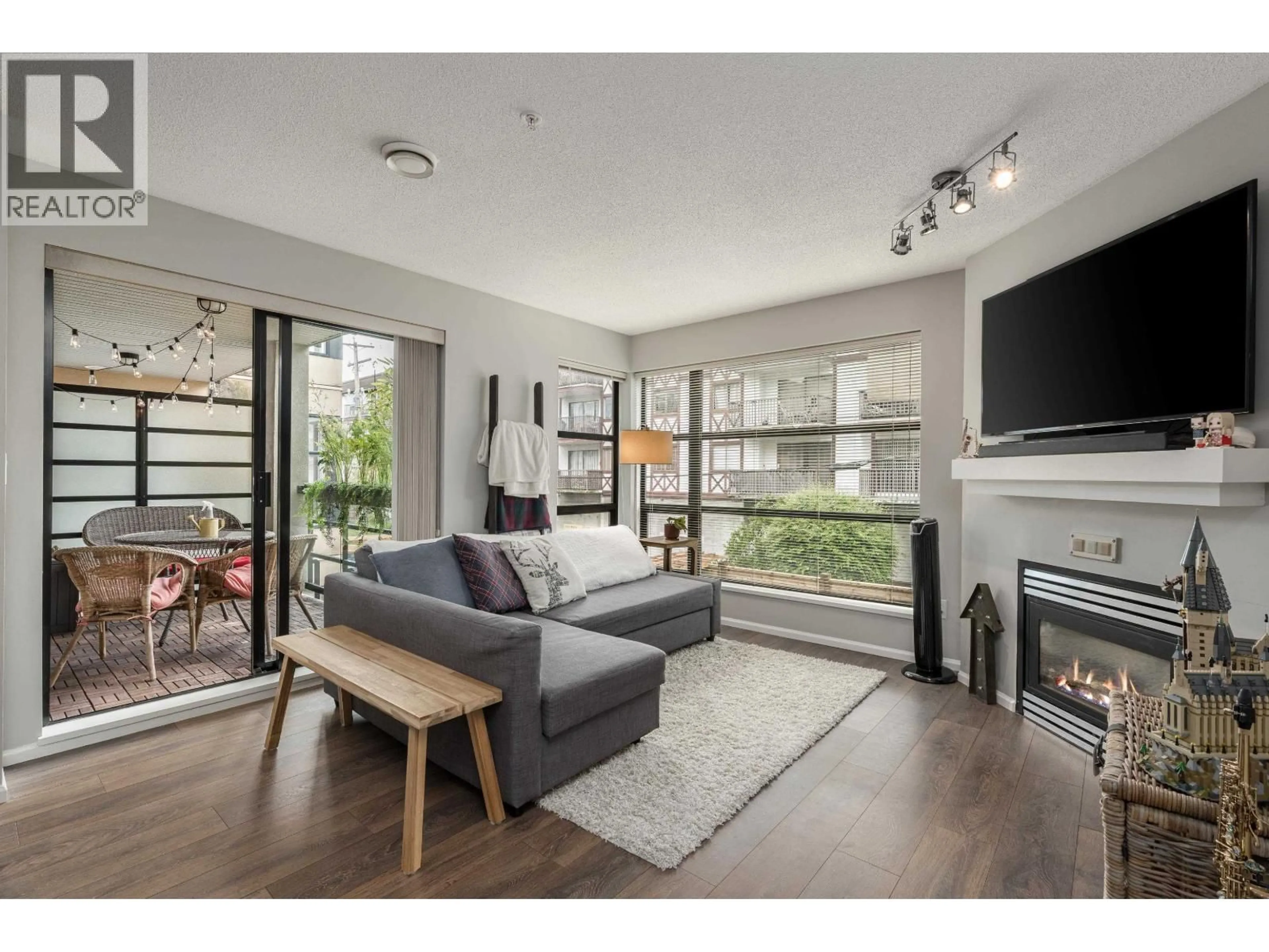 Living room with furniture, wood/laminate floor for 305 - 124 3RD STREET, North Vancouver British Columbia V7M1E8