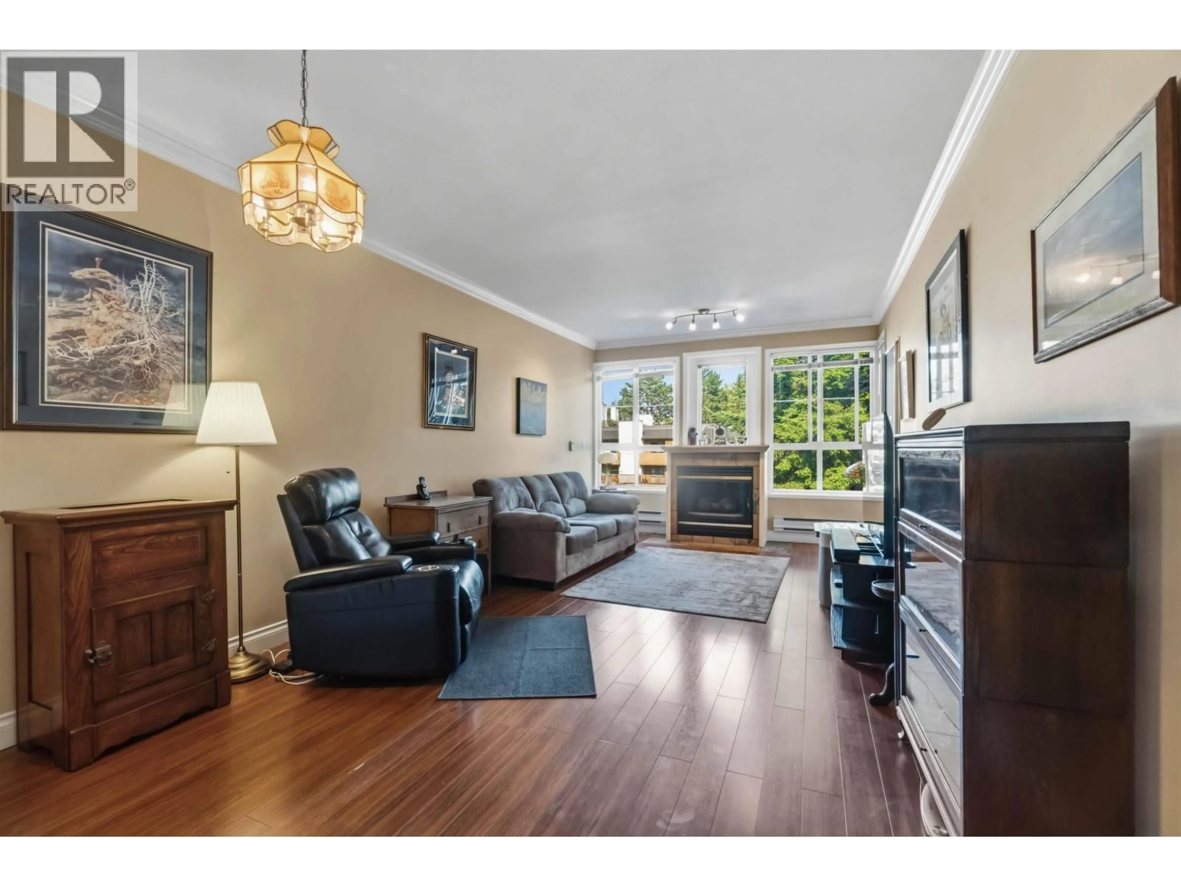 Living room with furniture, wood/laminate floor for 206 - 7300 GILBERT ROAD, Richmond British Columbia V7C3W2