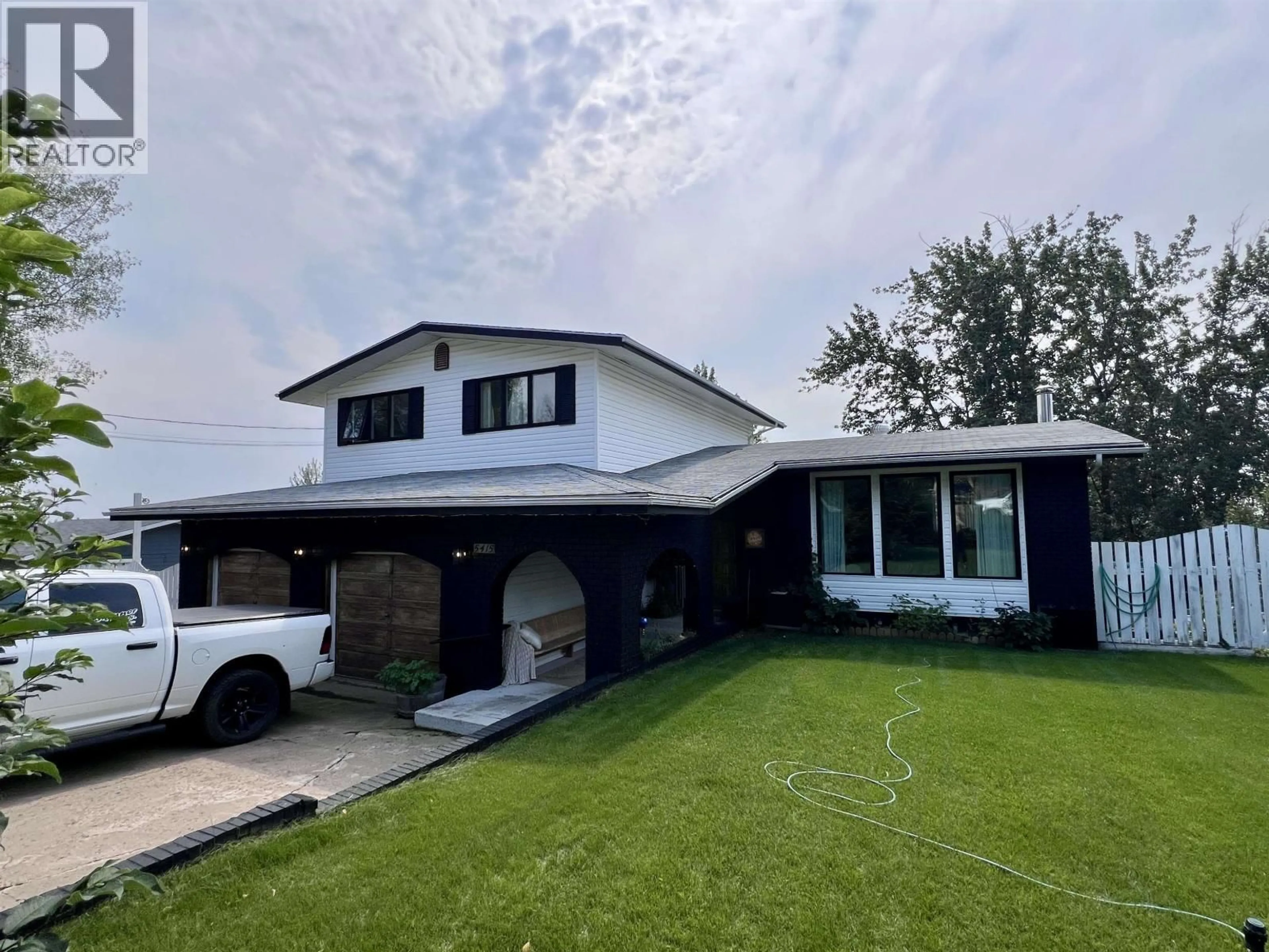 Home with vinyl exterior material, street for 5415 53 AVENUE, Fort Nelson British Columbia V0C1R0