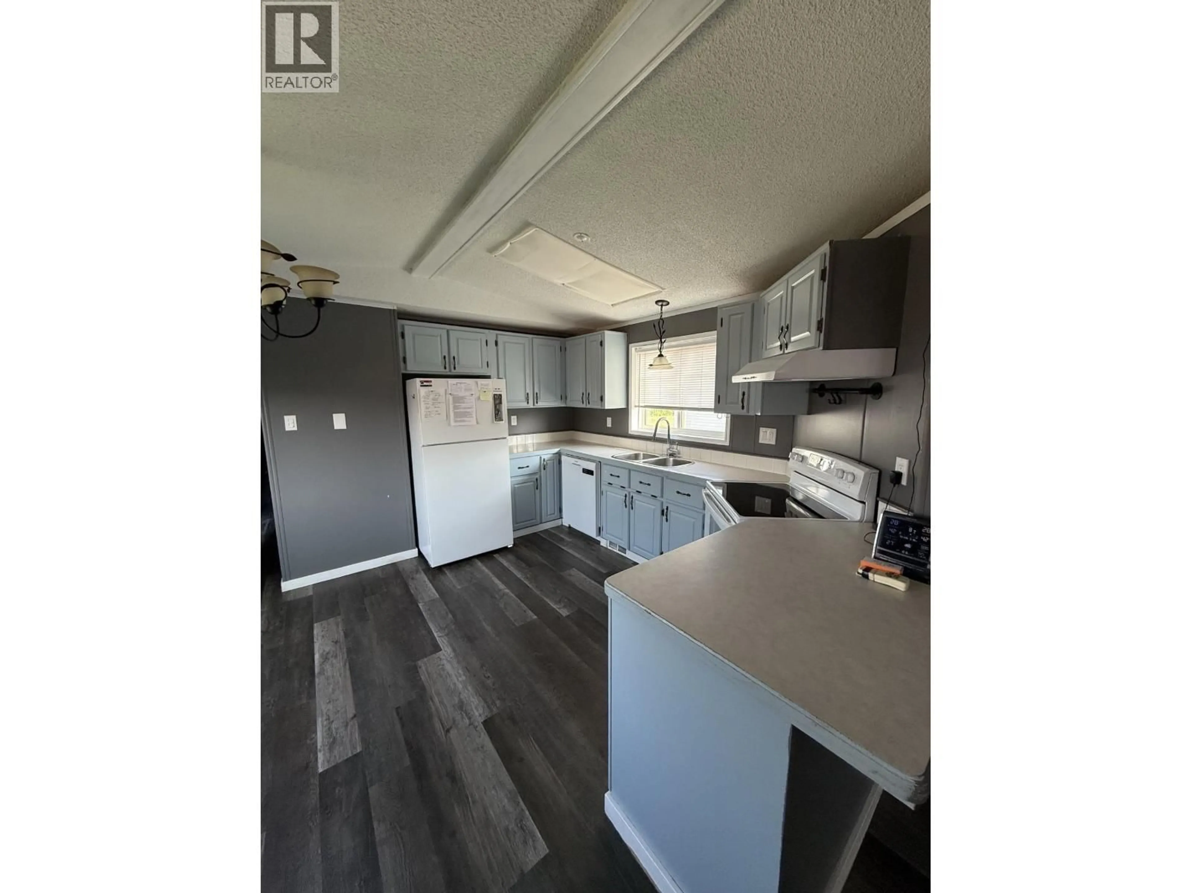 Open concept kitchen, wood/laminate floor for 169 - 9207 82 STREET, Fort St. John British Columbia V1J5G5
