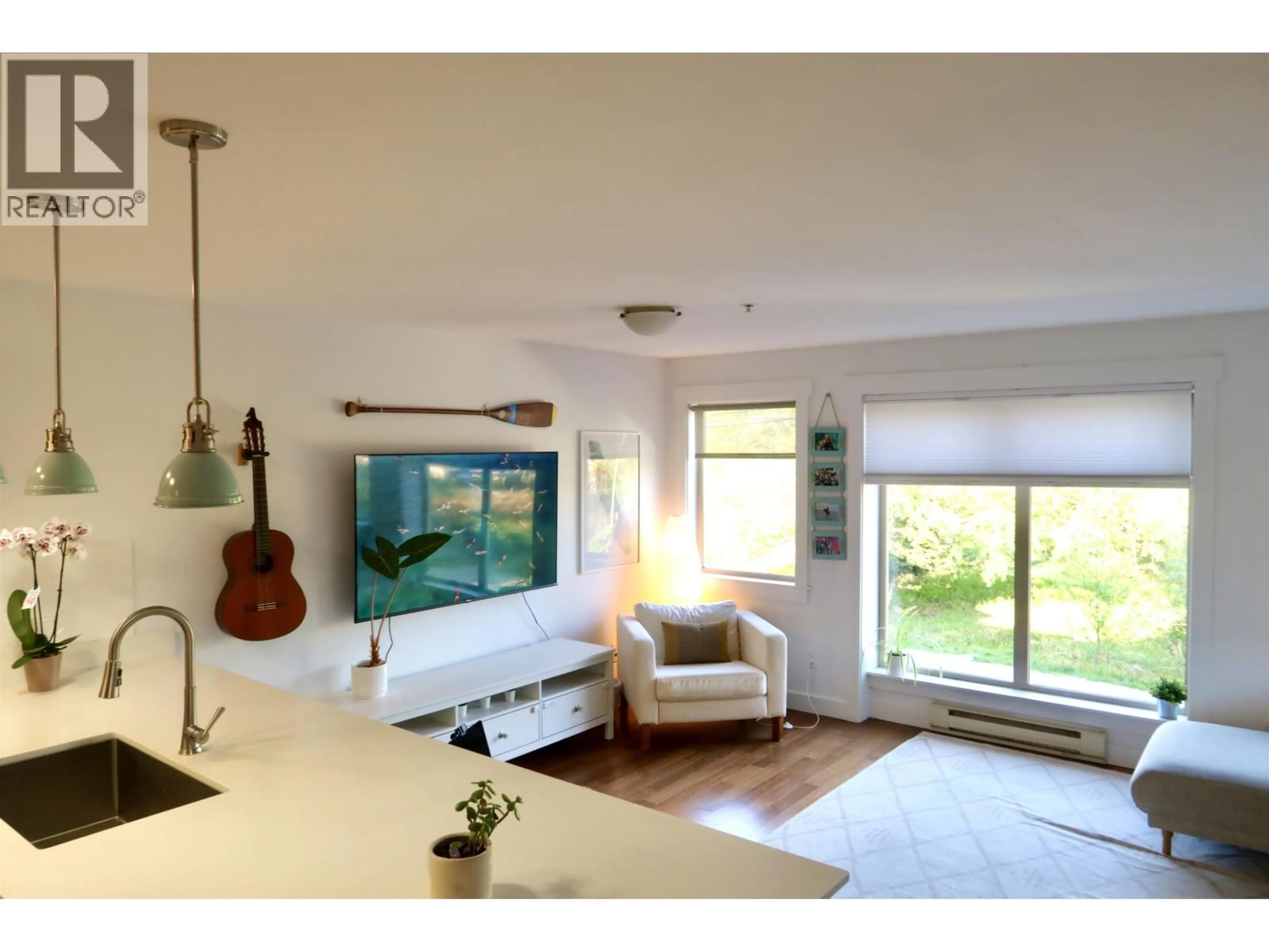 Living room with furniture, wood/laminate floor for 201 - 414 GOWER POINT ROAD, Gibsons British Columbia V0N1V0