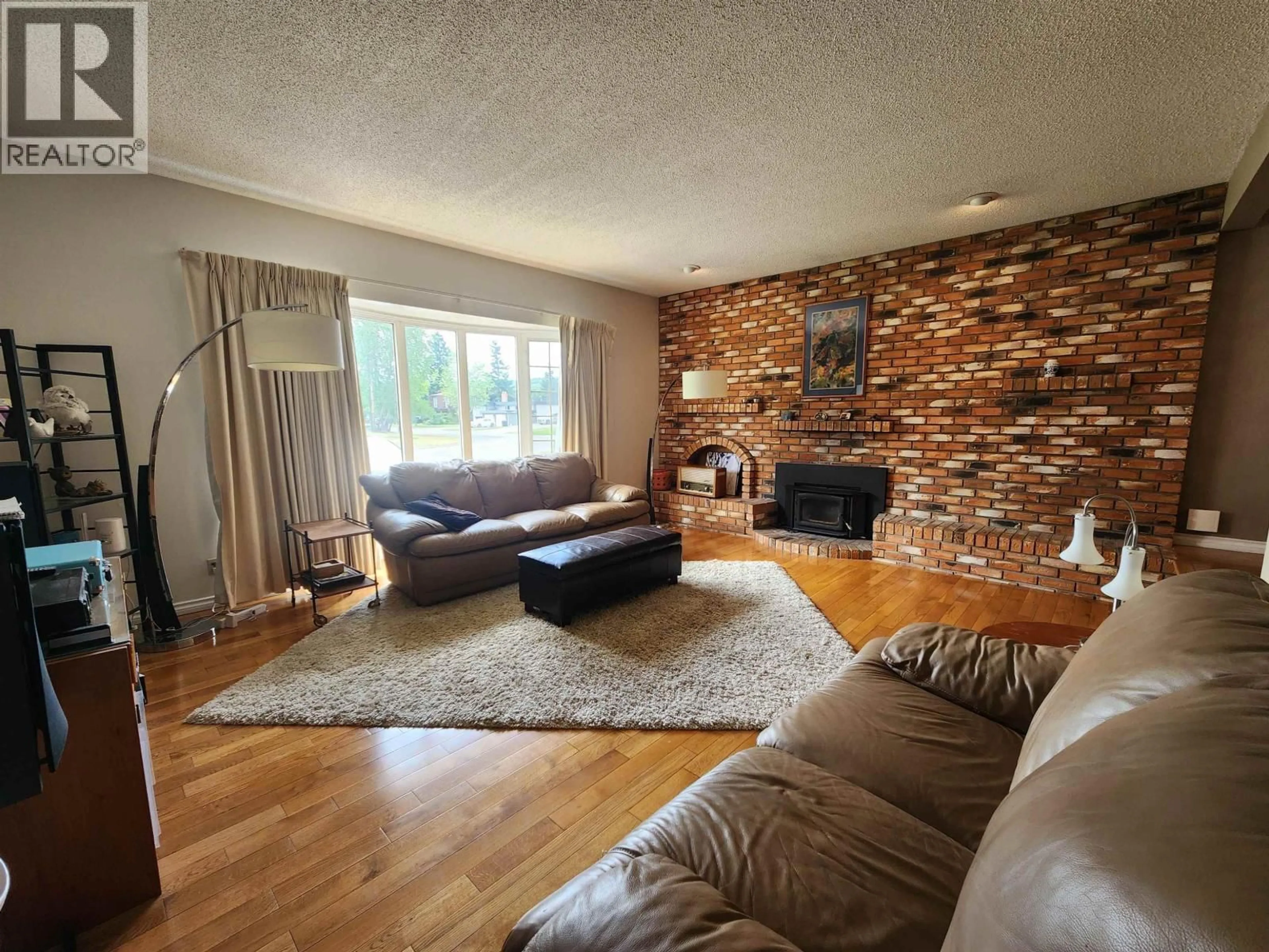 Living room with furniture, wood/laminate floor for 232 KING DRIVE, Prince George British Columbia V2M4V4