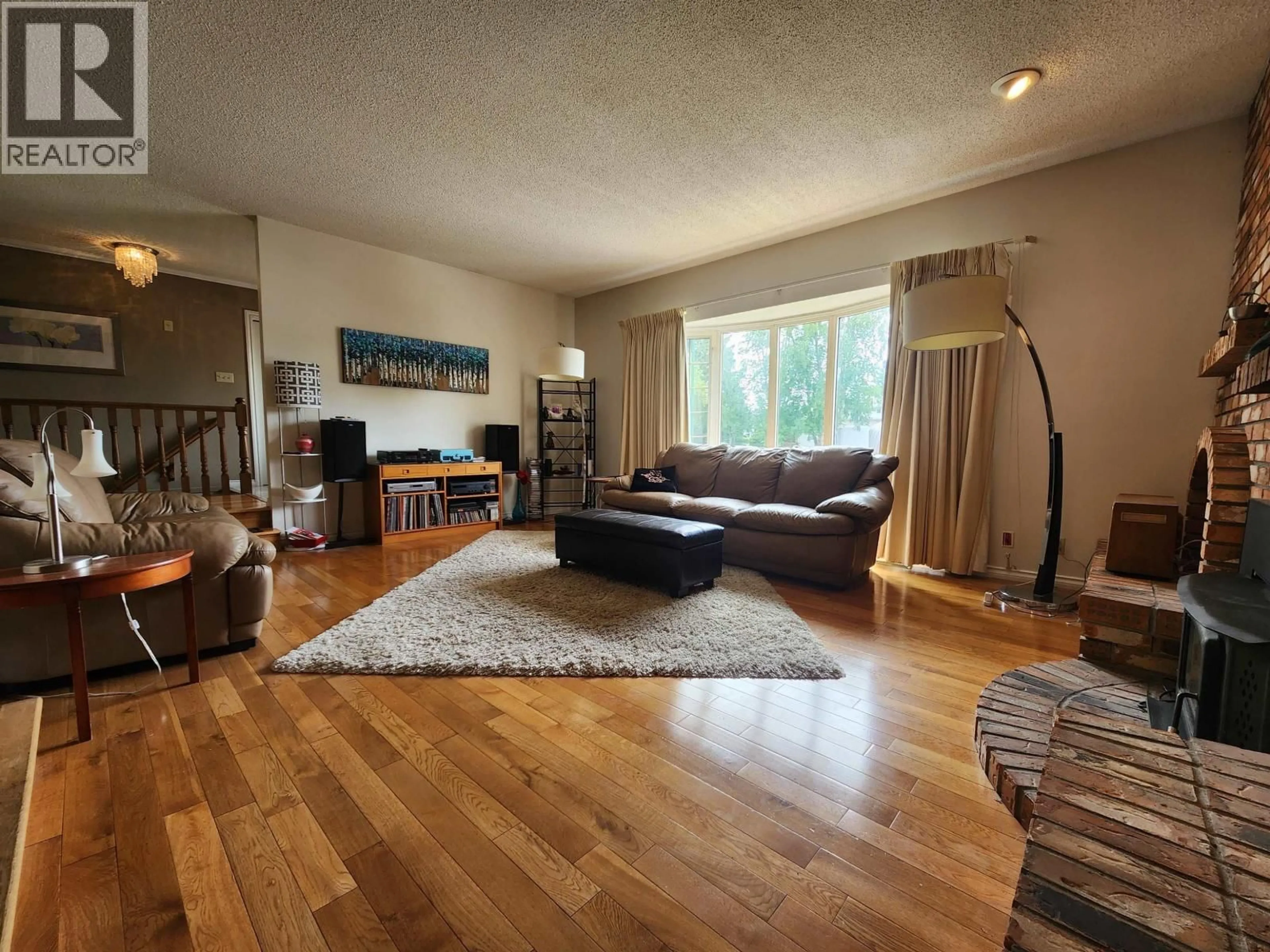 Living room with furniture, wood/laminate floor for 232 KING DRIVE, Prince George British Columbia V2M4V4