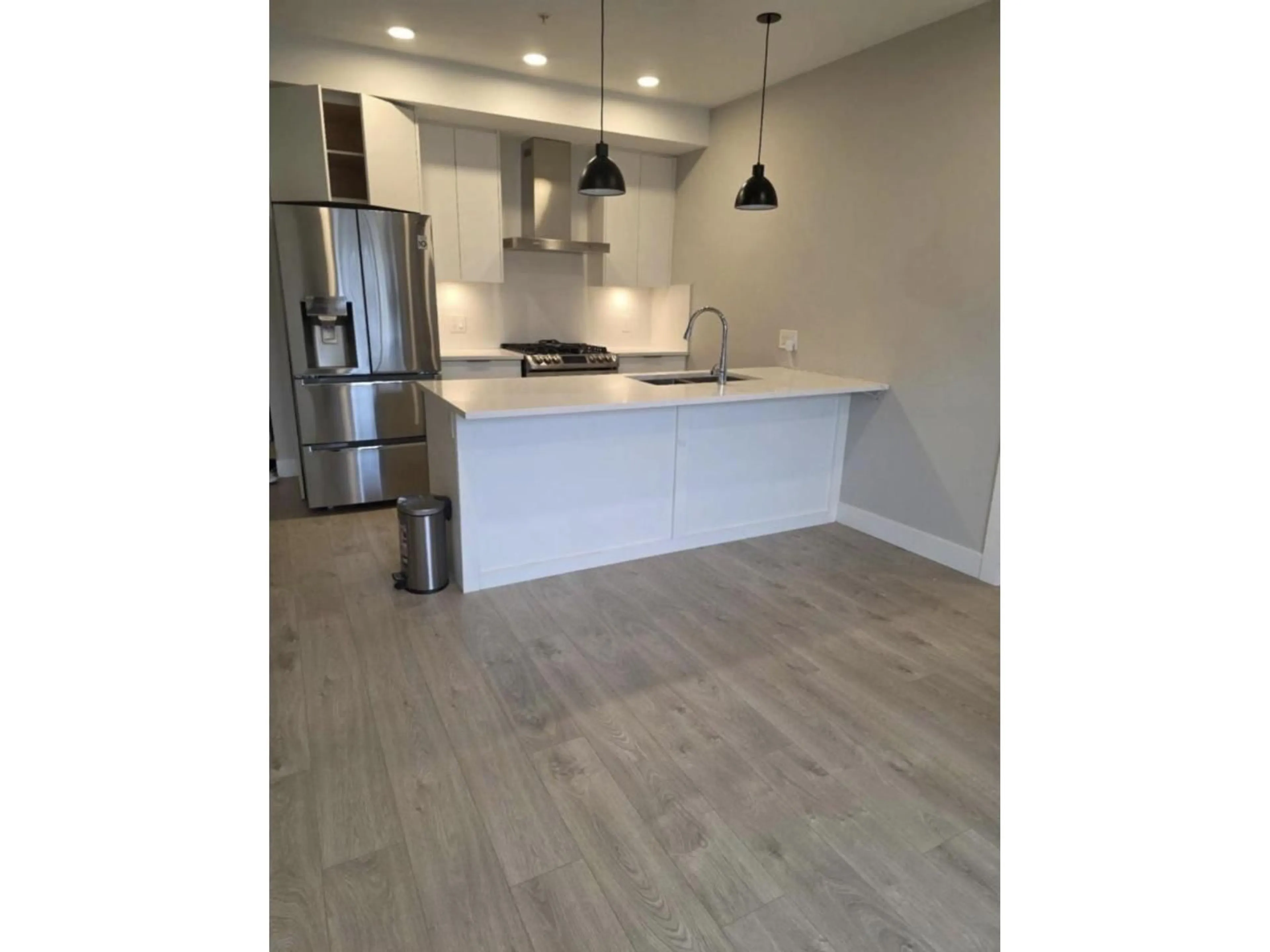 Open concept kitchen, wood/laminate floor for 211 - 14818 60 AVENUE, Surrey British Columbia V3S1R9