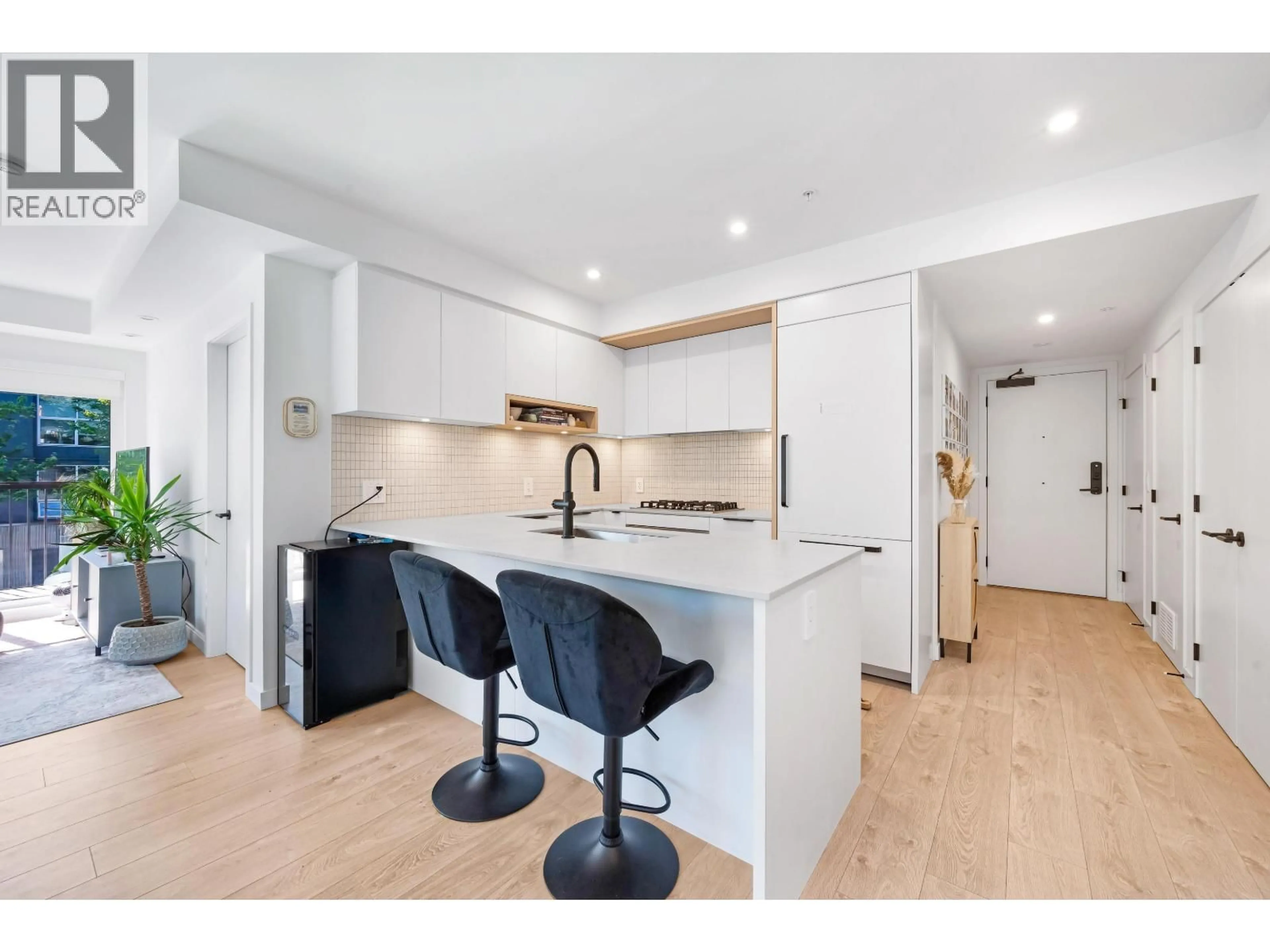 Open concept kitchen, wood/laminate floor for 221 - 2520 GUELPH STREET, Vancouver British Columbia V5T0K7