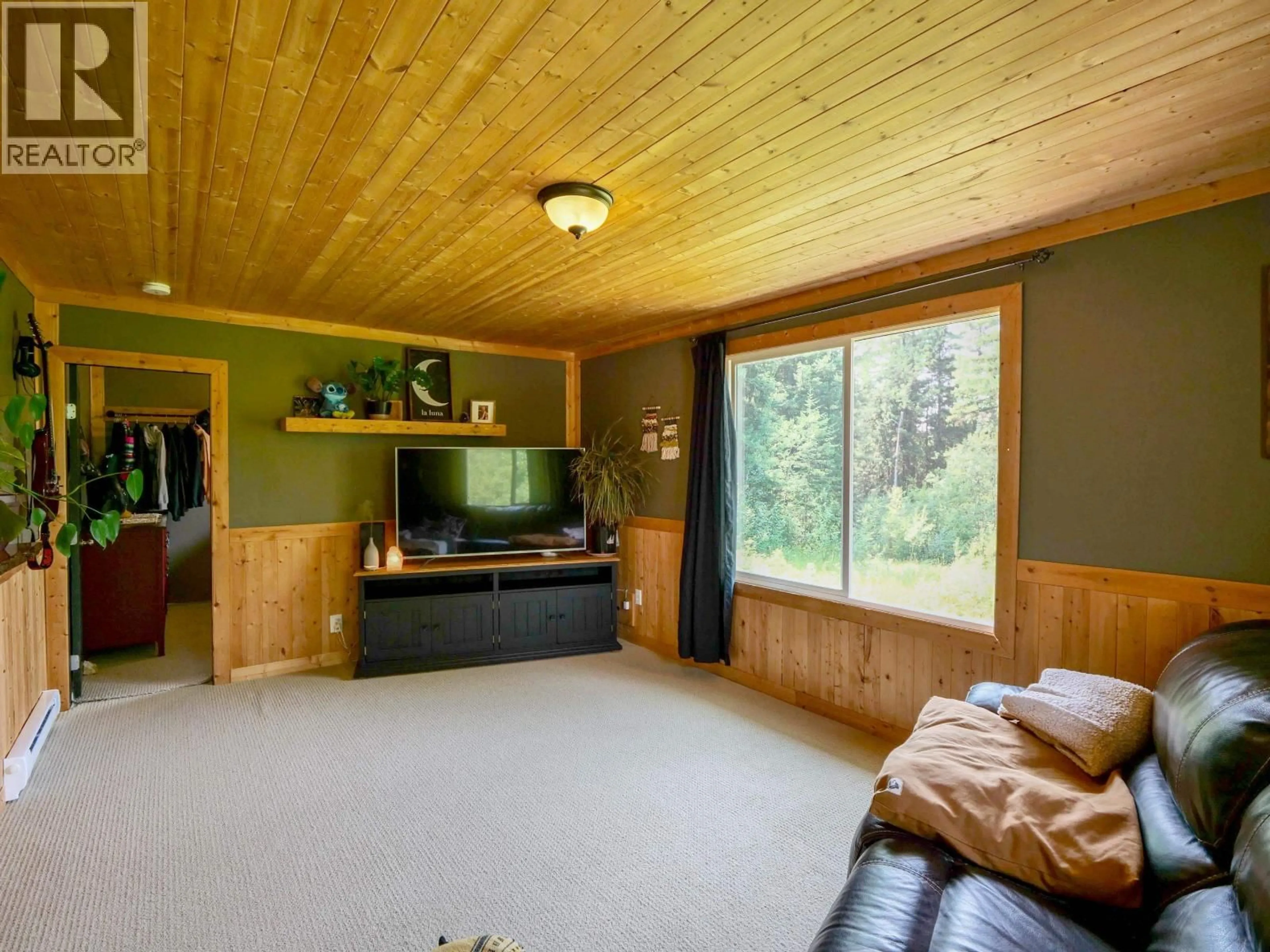 Living room with furniture, wood/laminate floor for 3861 HILLCREST ROAD, Quesnel British Columbia V2J6T6