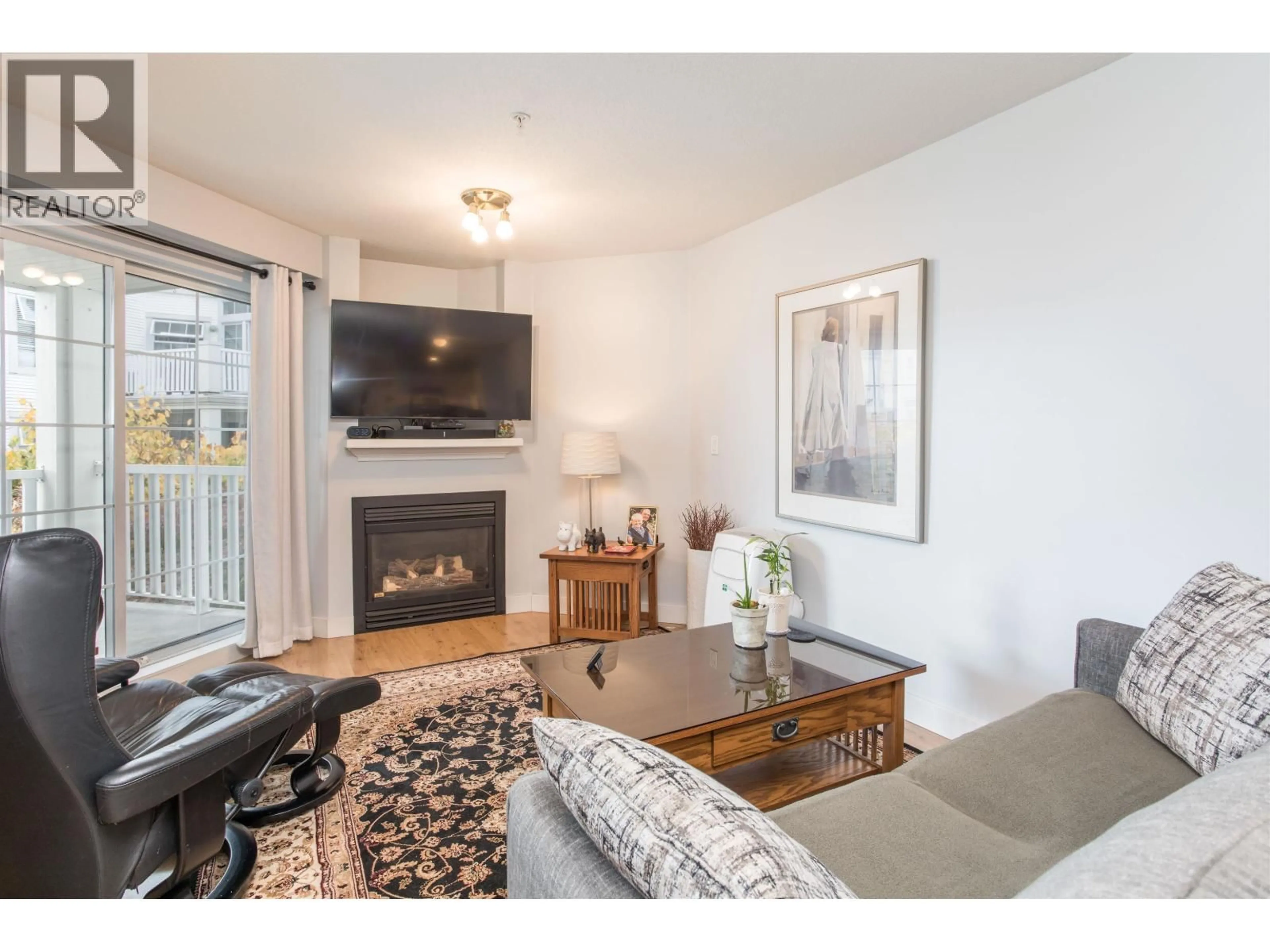 Living room with furniture, wood/laminate floor for 313 - 147 1ST STREET, North Vancouver British Columbia V7L1B2
