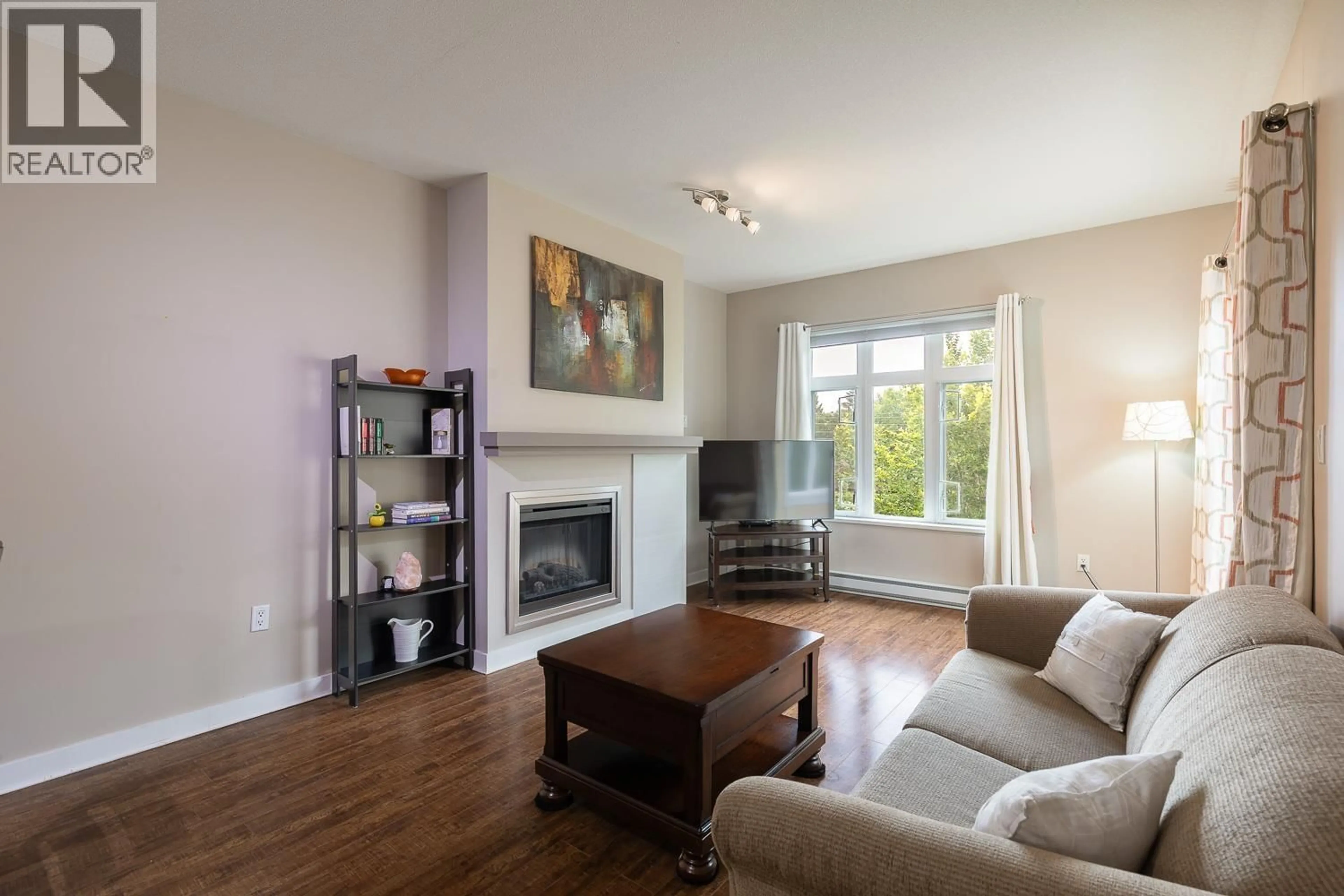 Living room with furniture, wood/laminate floor for 405 - 2368 MARPOLE AVENUE, Port Coquitlam British Columbia V3C0B4