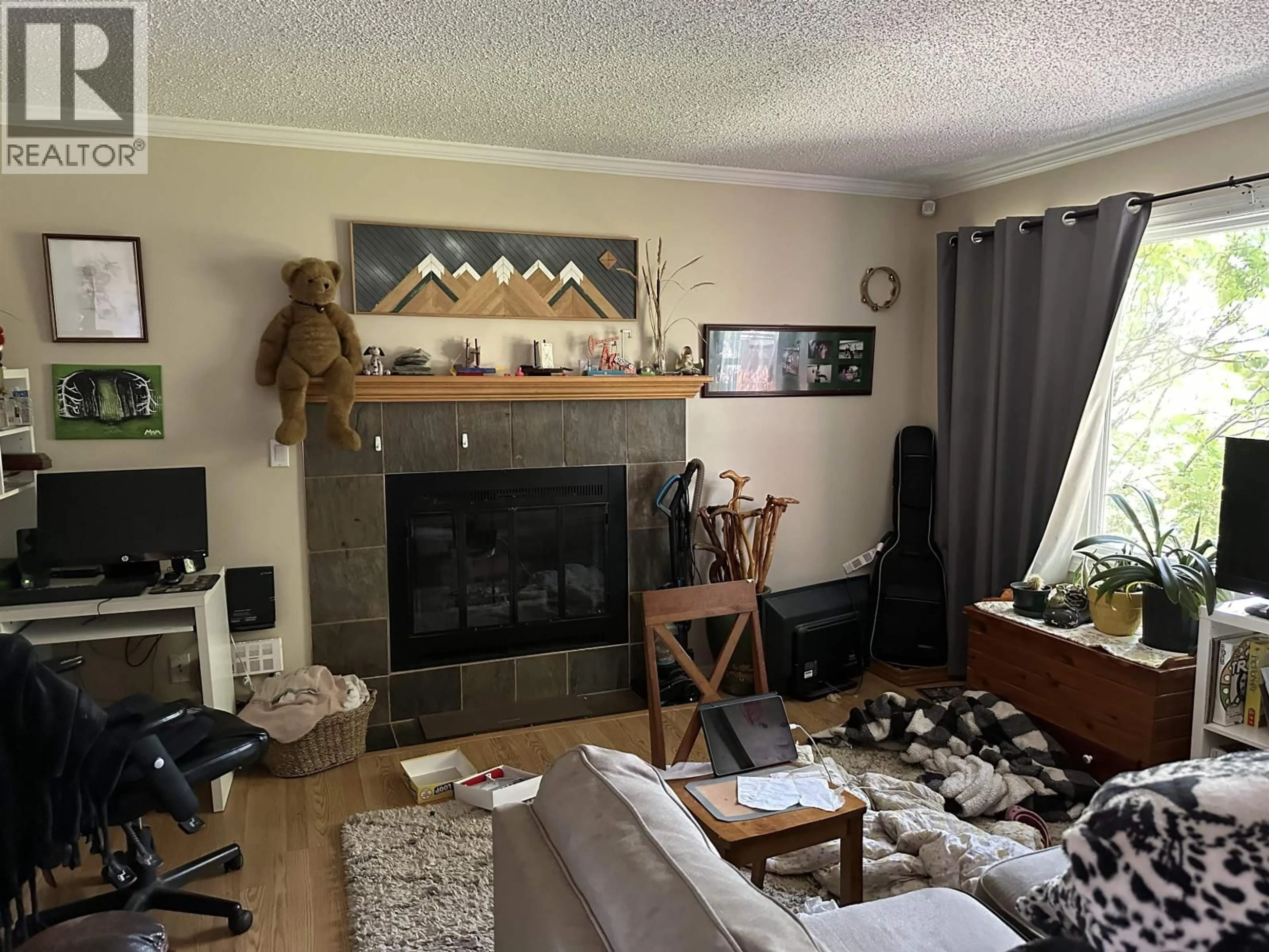 Living room with furniture, wood/laminate floor for 8519 87 STREET, Fort St. John British Columbia V1J5T9