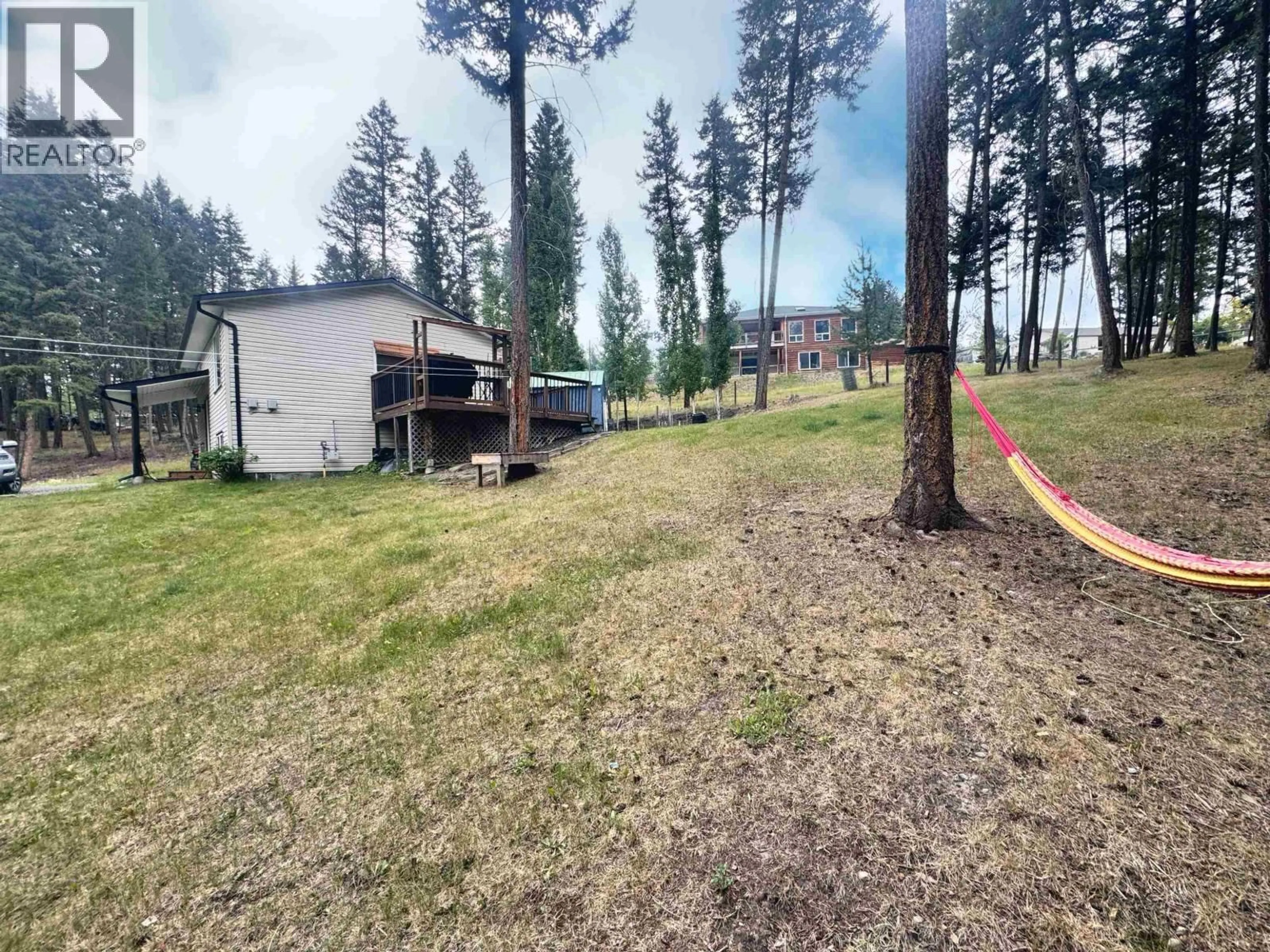 A pic from outside/outdoor area/front of a property/back of a property/a pic from drone, forest/trees view for 4865 CUMSU PLACE, 108 Mile Ranch British Columbia V0K2Z0