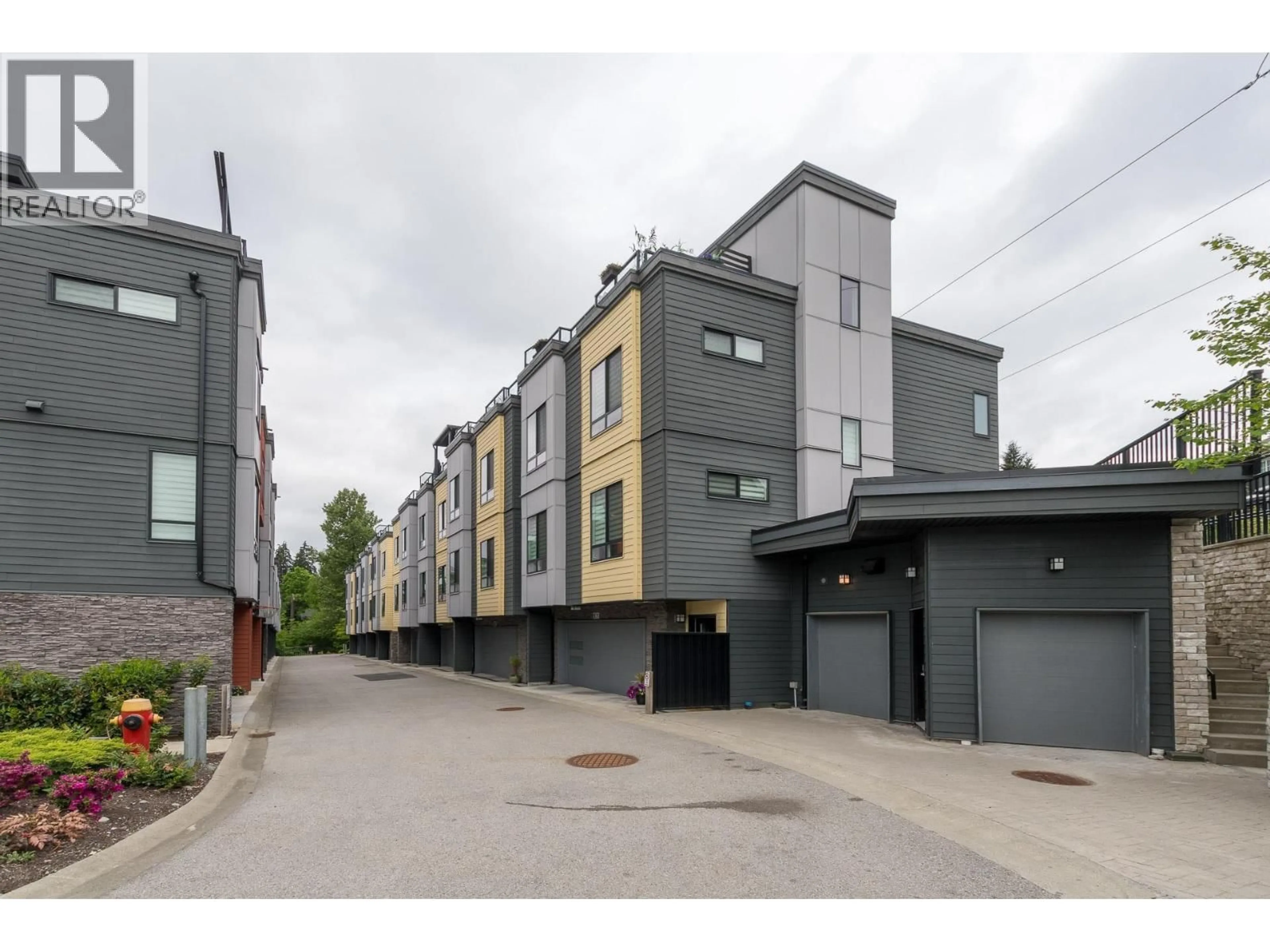 A pic from outside/outdoor area/front of a property/back of a property/a pic from drone, street for 102 - 3503 GISLASON AVENUE, Coquitlam British Columbia V3E0T1