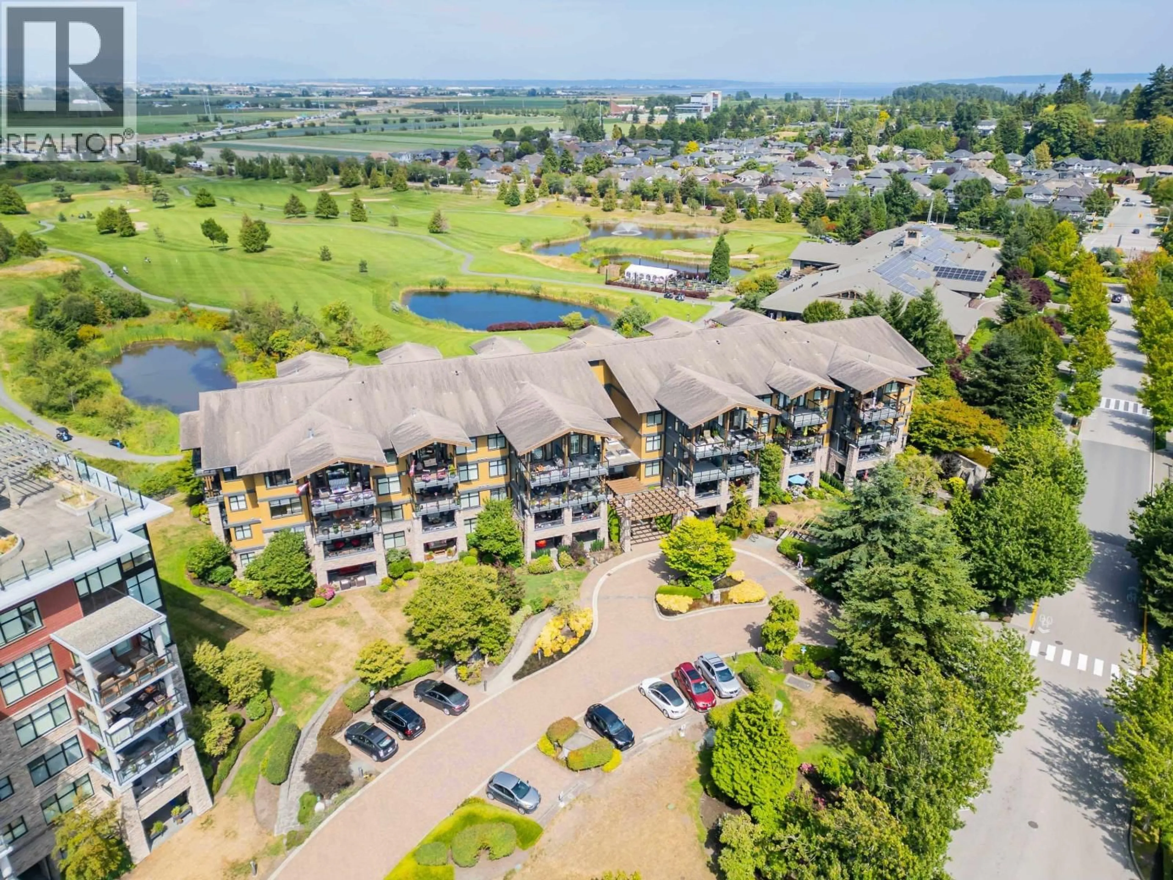 A pic from outside/outdoor area/front of a property/back of a property/a pic from drone, water/lake/river/ocean view for 301 - 5099 SPRINGS BOULEVARD, Delta British Columbia V4M0A2