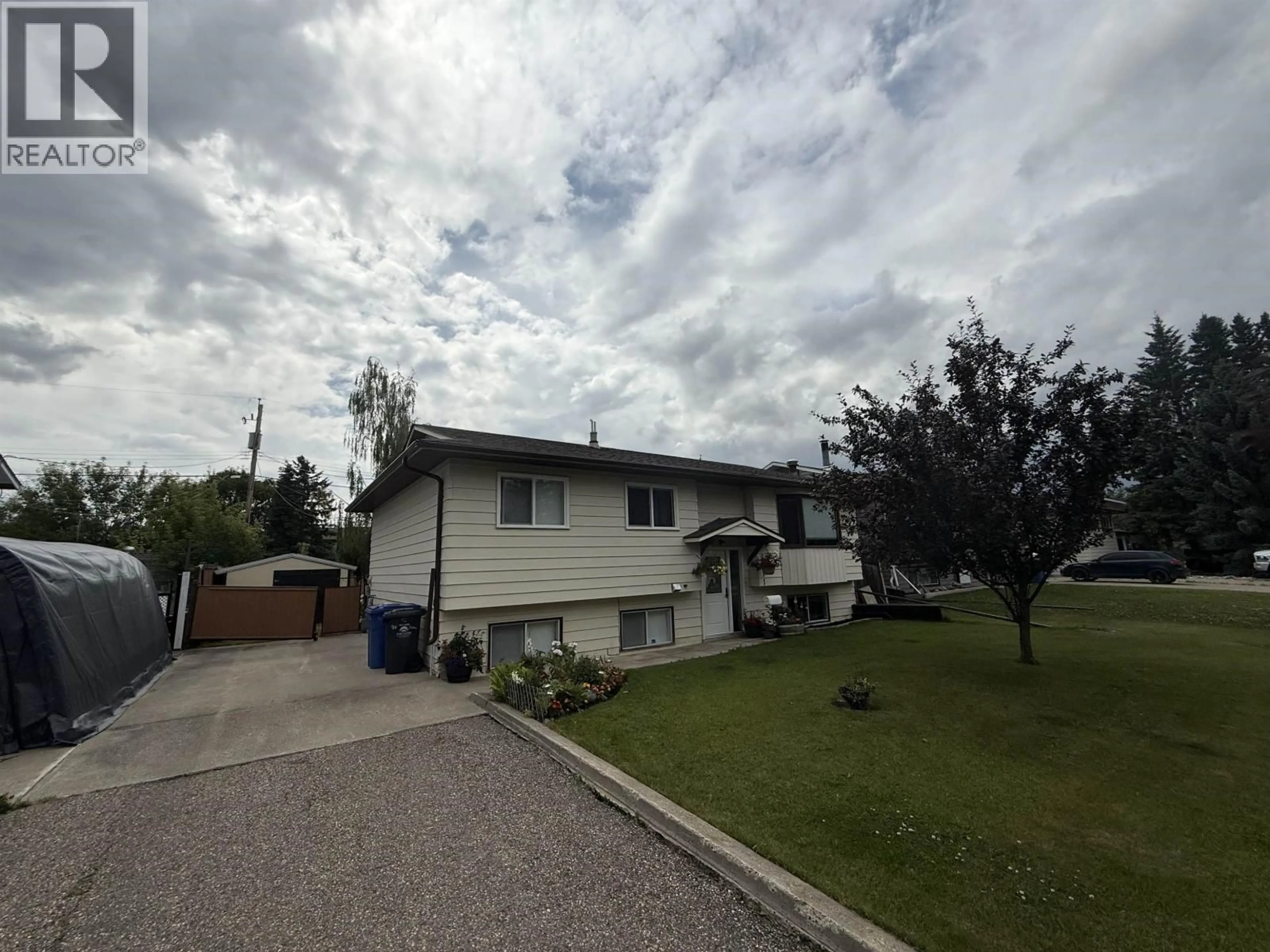 A pic from outside/outdoor area/front of a property/back of a property/a pic from drone, street for 9111 117 AVENUE, Fort St. John British Columbia V1J6A6