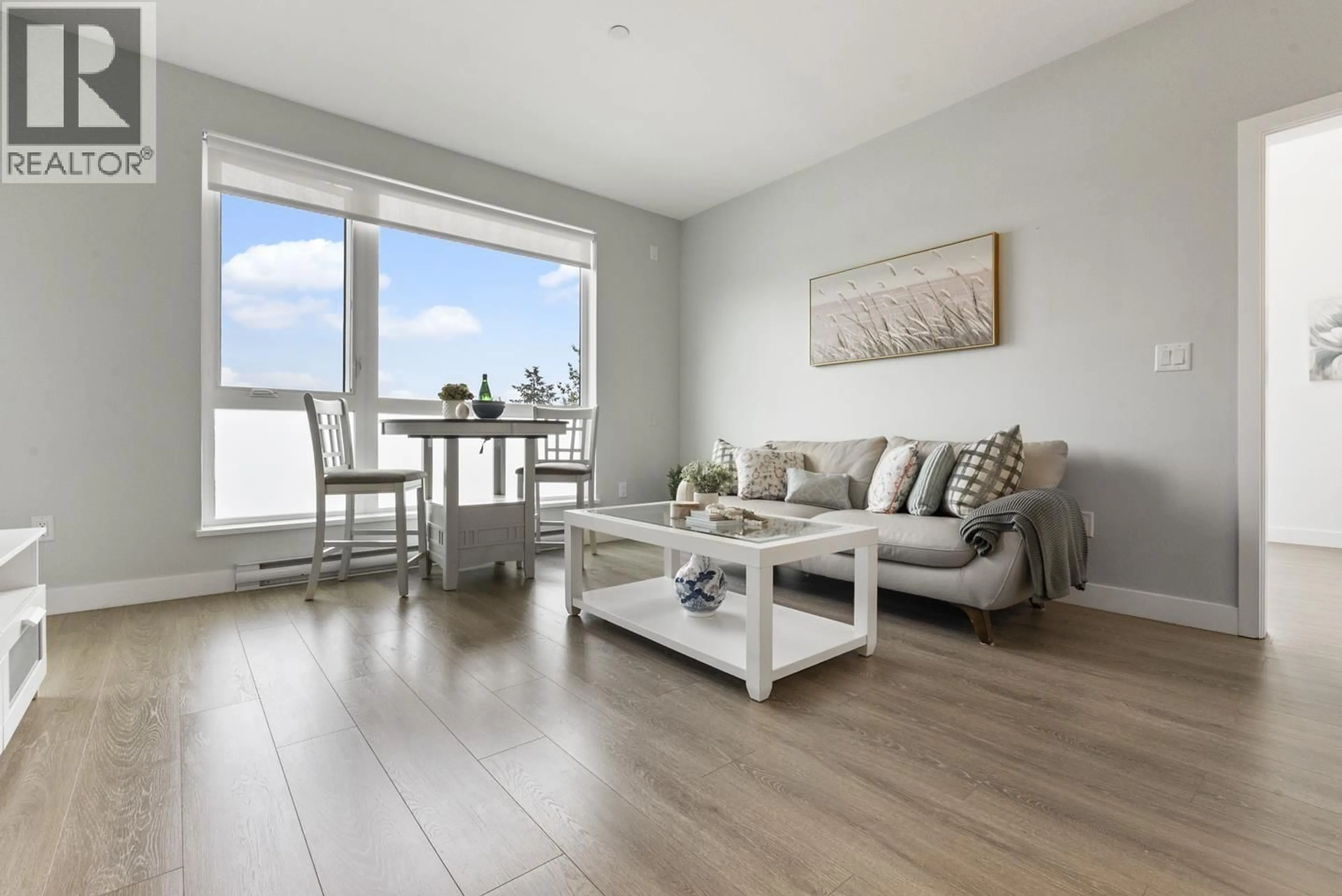 Living room with furniture, wood/laminate floor for 405 - 11703 FRASER STREET, Maple Ridge British Columbia V2X9A7