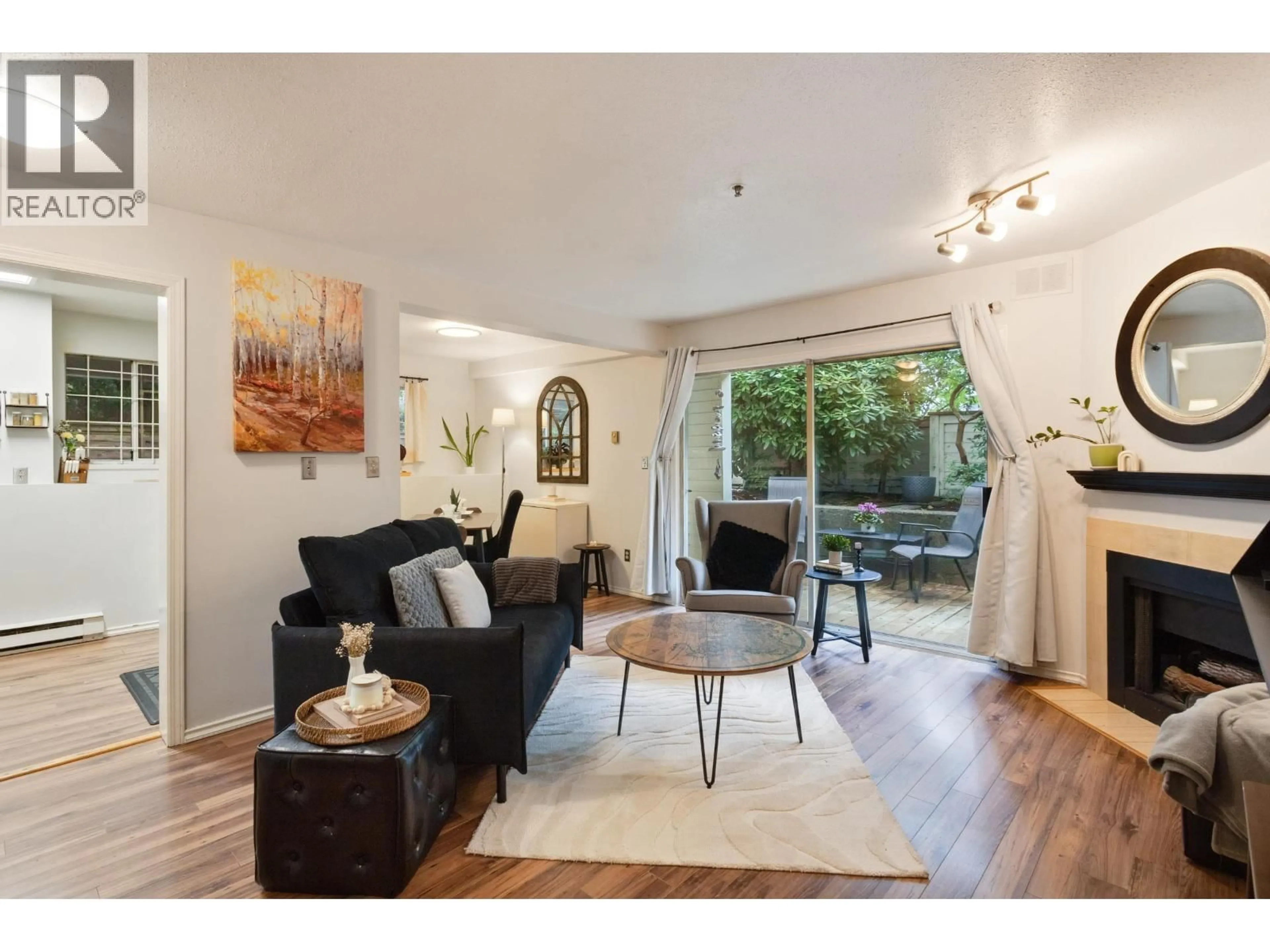 Living room with furniture, wood/laminate floor for 101 - 3270 W 4TH AVENUE, Vancouver British Columbia V6K1R9