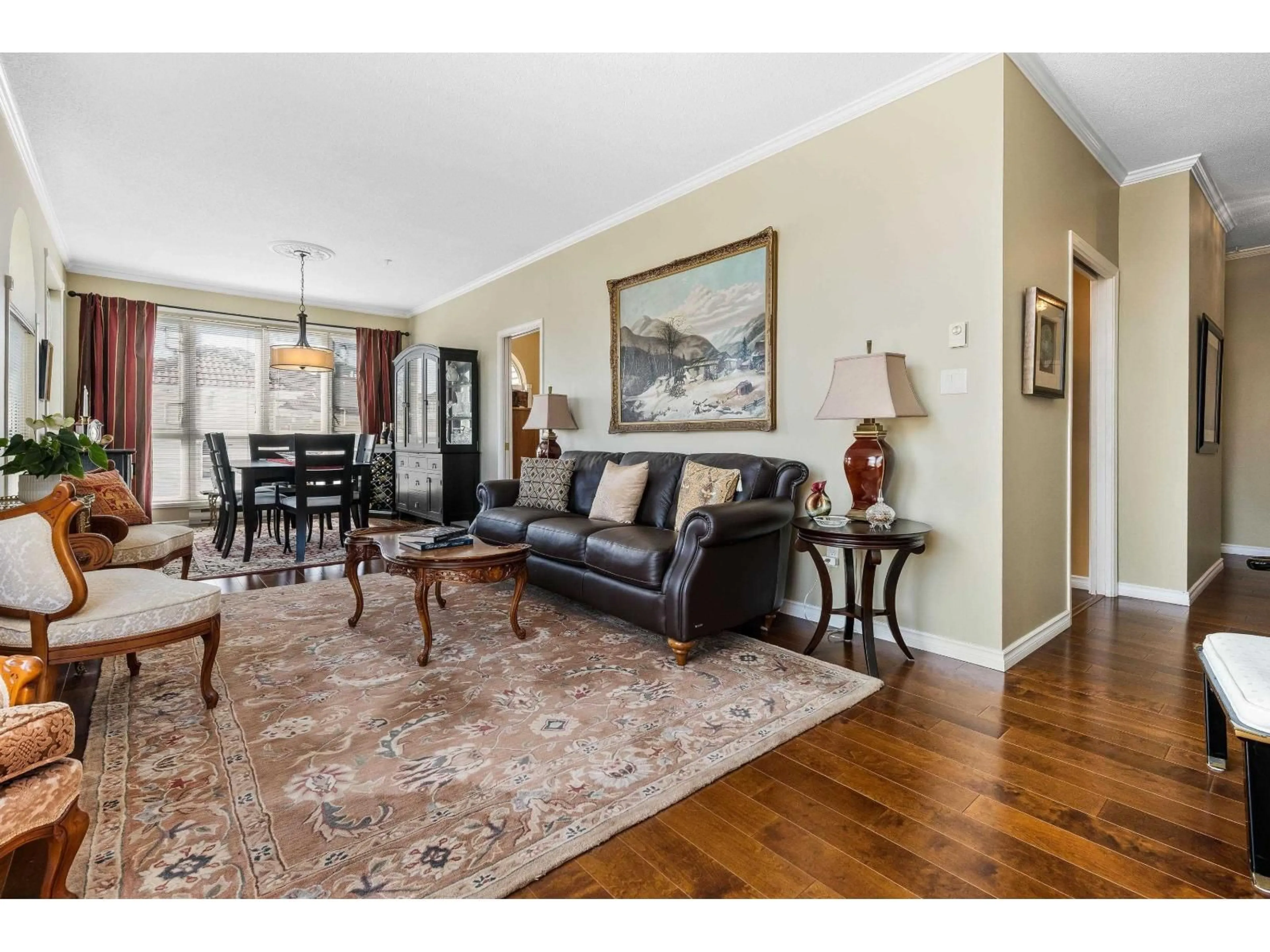 Living room with furniture, wood/laminate floor for 402 - 3172 GLADWIN ROAD, Abbotsford British Columbia V2T5T3
