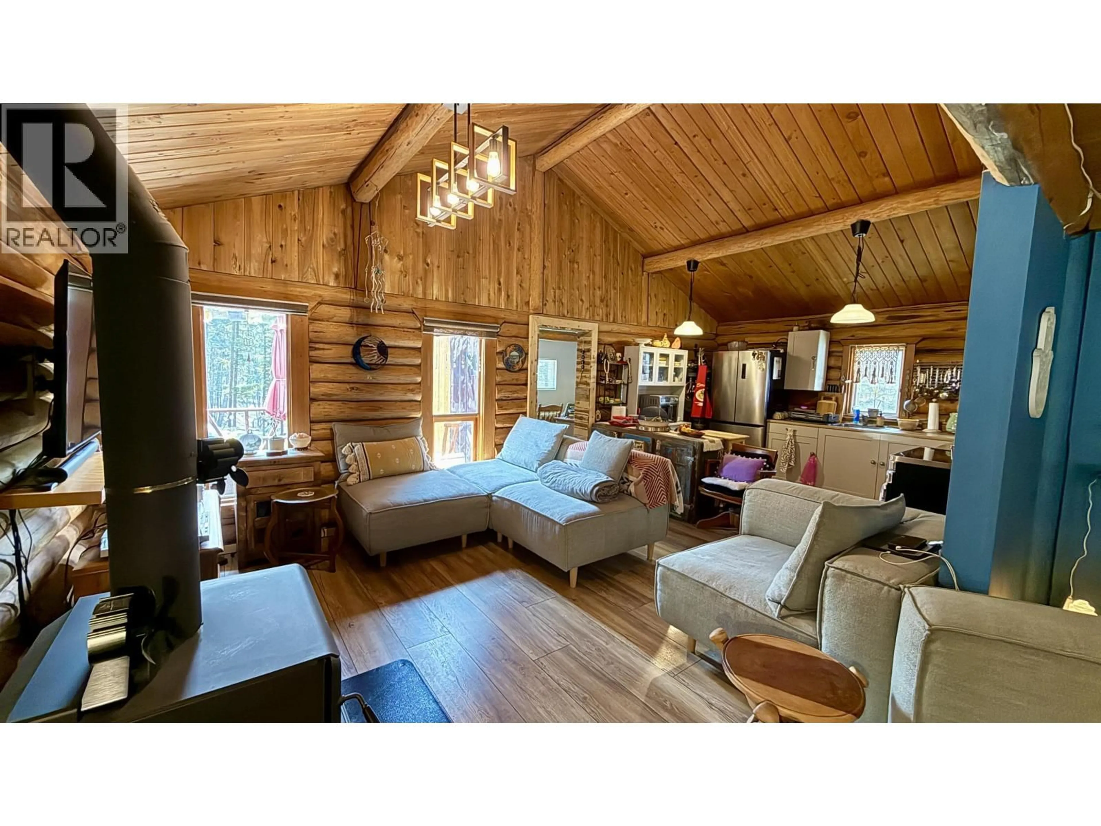 Living room with furniture, wood/laminate floor for 4863 CUMSU PLACE, 108 Mile Ranch British Columbia V0K2Z0