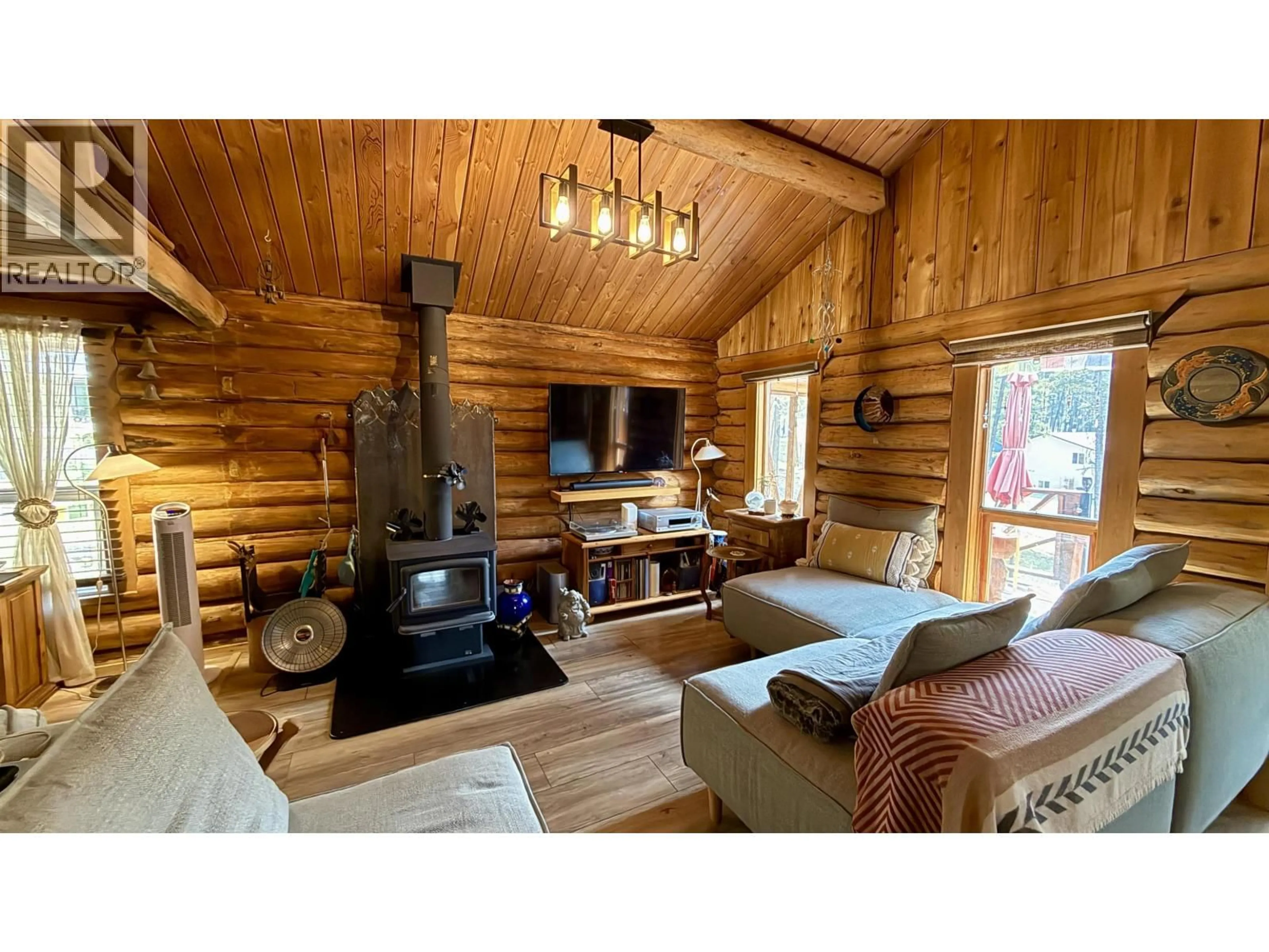 Living room with furniture, wood/laminate floor for 4863 CUMSU PLACE, 108 Mile Ranch British Columbia V0K2Z0