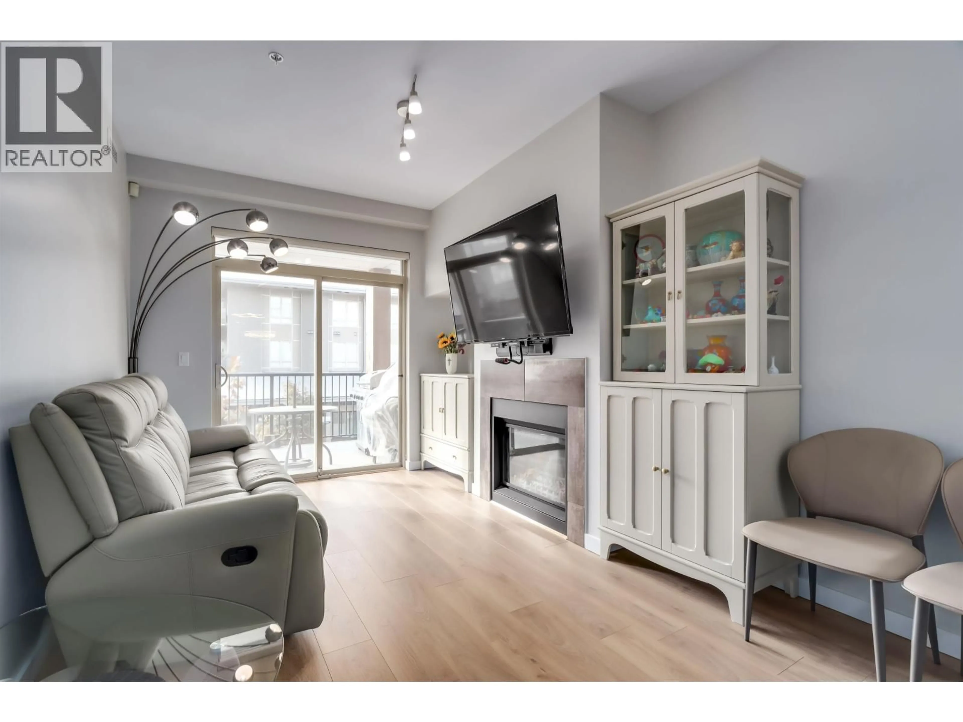 Living room with furniture, wood/laminate floor for 204 - 6077 LONDON ROAD, Richmond British Columbia V7E0A7