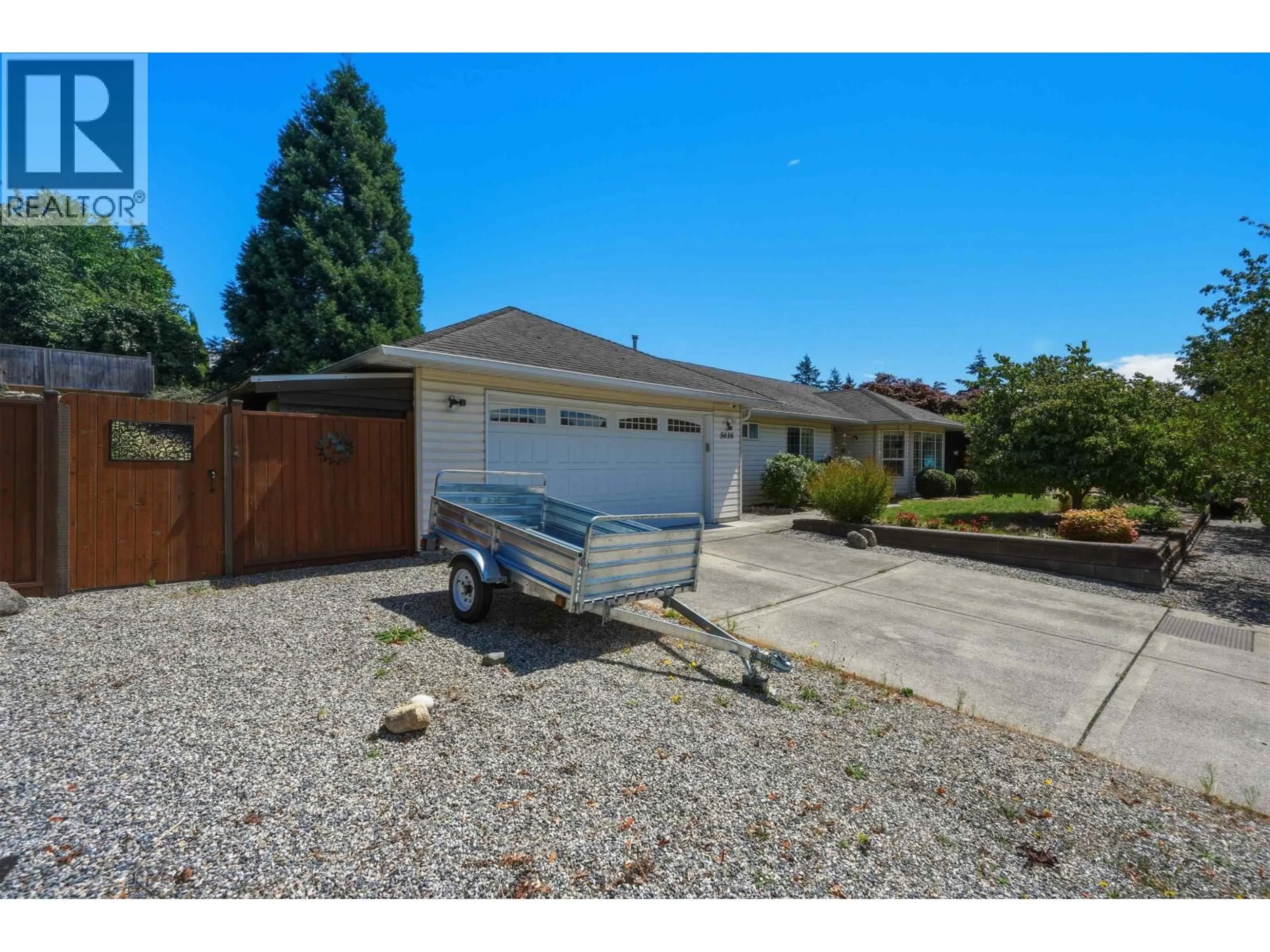A pic from outside/outdoor area/front of a property/back of a property/a pic from drone, street for 5616 EMERSON ROAD, Sechelt British Columbia V0N3A7