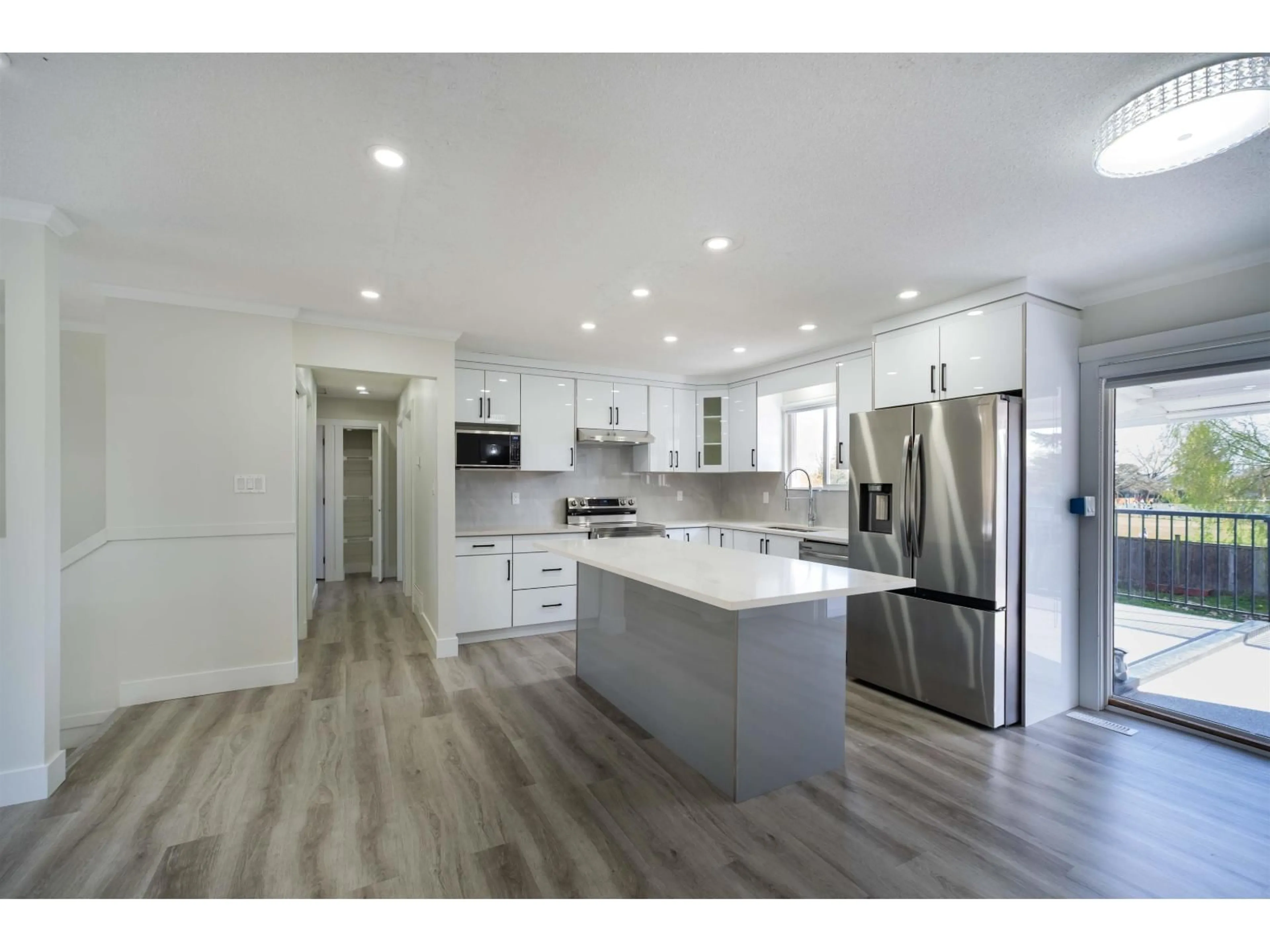 Open concept kitchen, wood/laminate floor for 17396 62A AVENUE, Surrey British Columbia V3S5J1