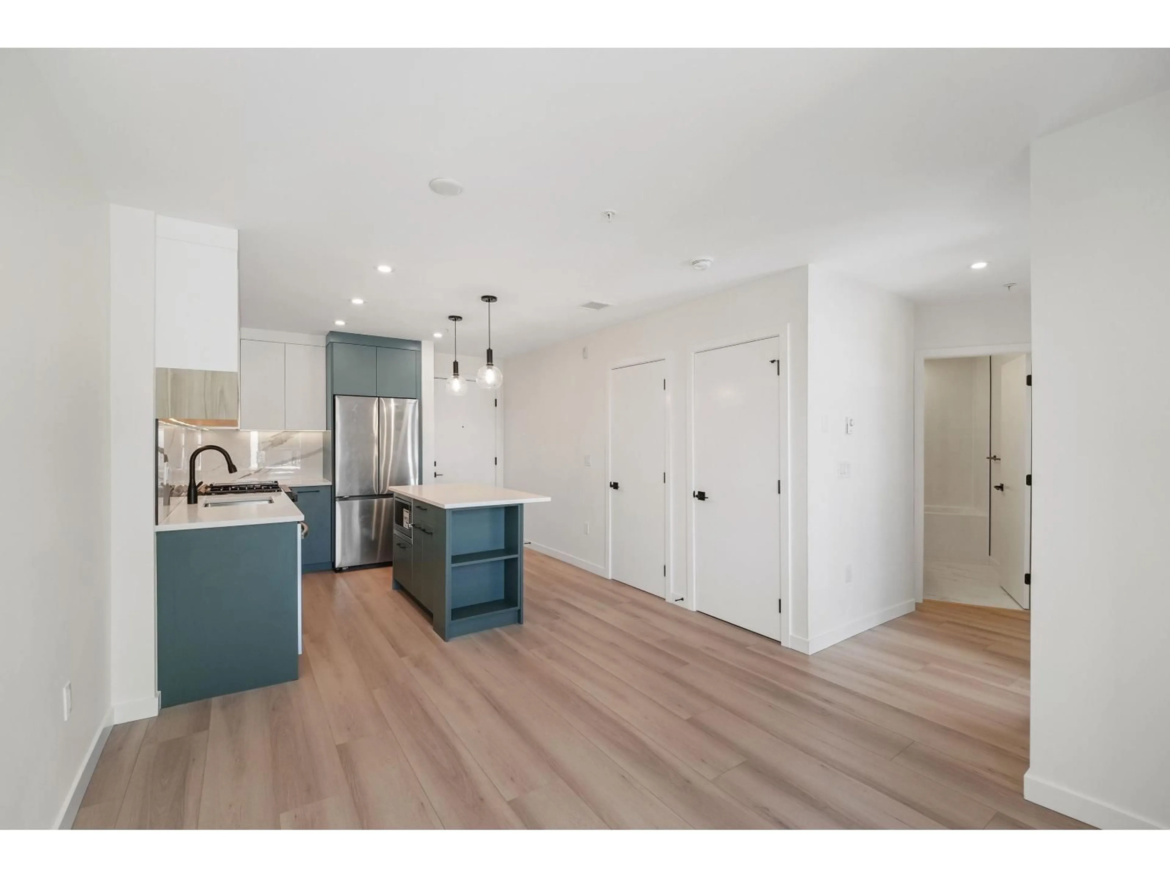 Open concept kitchen, wood/laminate floor for 409 - 6270 GOOSEBERRY DRIVE, Surrey British Columbia V3S0B7