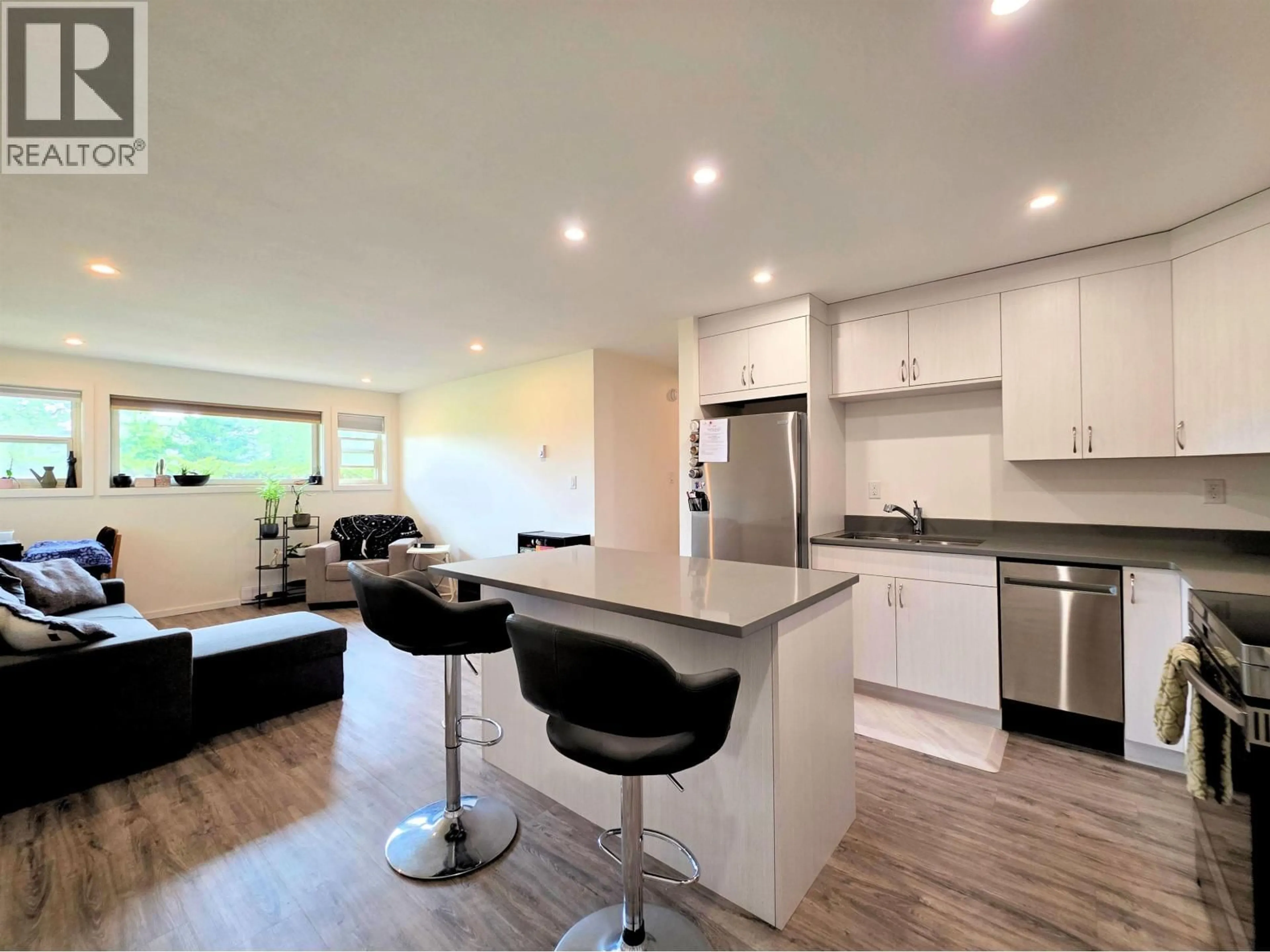 Open concept kitchen, wood/laminate floor for 106 - 3777 MASSEY DRIVE, Prince George British Columbia V2N4J6